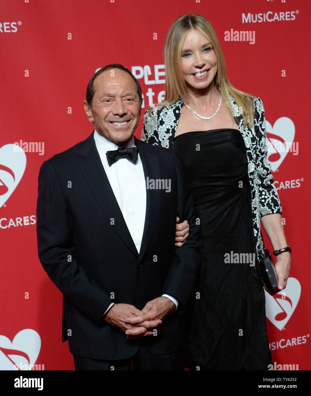 Singer and songwriter Paul Anka and Lisa Lisa Pemberton arrive for the  MusiCares Person of the Year gala held at the Los Angeles Convention Center  in Los Angeles on February 13, 2016.