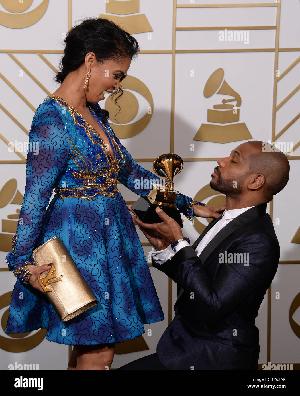 Songwriter Kirk Franklin holds his Best Gospel Performance/Song trophy for 'Wanna Be Happy?' and Tammy Collins appear backstage during the 58th annual Grammy Awards held at Staples Center in Los Angeles on February 15, 2016. Photo by Phil McCarten/UPI Stock Photo