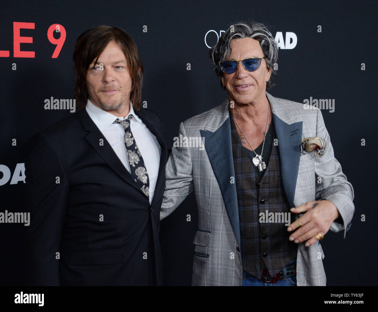 Cast member Norman Reedus (L) and actor Mickey Rourke attend the premiere  of the motion picture crime thriller "Triple 9" at Regal L.A. Live in Los  Angeles on February 16, 2016. Storyline: