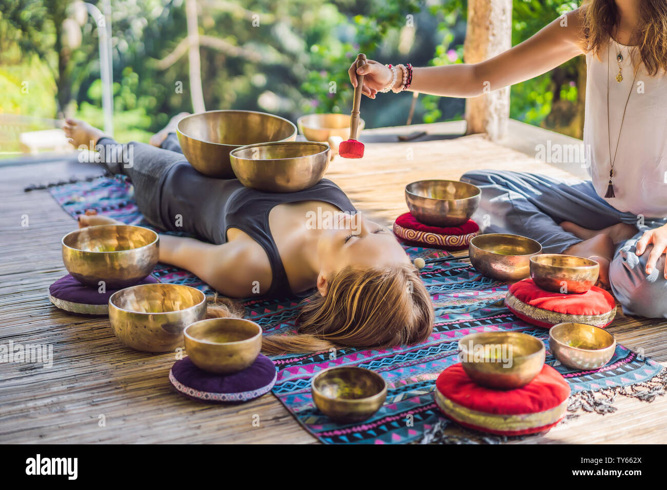 Nepal Buddha copper singing bowl at spa salon. Young beautiful woman doing  massage therapy singing bowls in the Spa against a waterfall. Sound therapy  Stock Photo - Alamy