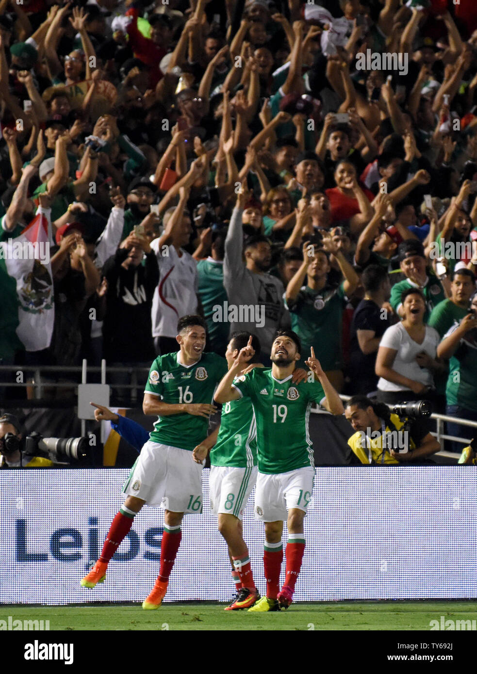 Mexico forward Oribe Peralta (19) celebrates with teammates Hector Herrera (16) and forward Hirving Lozano, center, after Peralta's score against Jamaica during the second half of a 2016 Copa America Centenario Group A match at the Rose Bowl in Pasadena, California, on June 9, 2016. Mexico defeated Jamaica 2-0. Photo by Michael Owen Baker/UPI Stock Photo