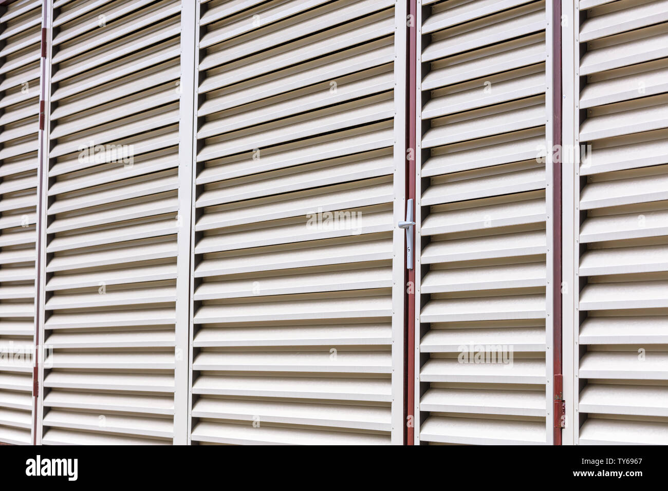 exterior view of warehouse building. vent wall pattern. abstract striped background of metal louvers Stock Photo