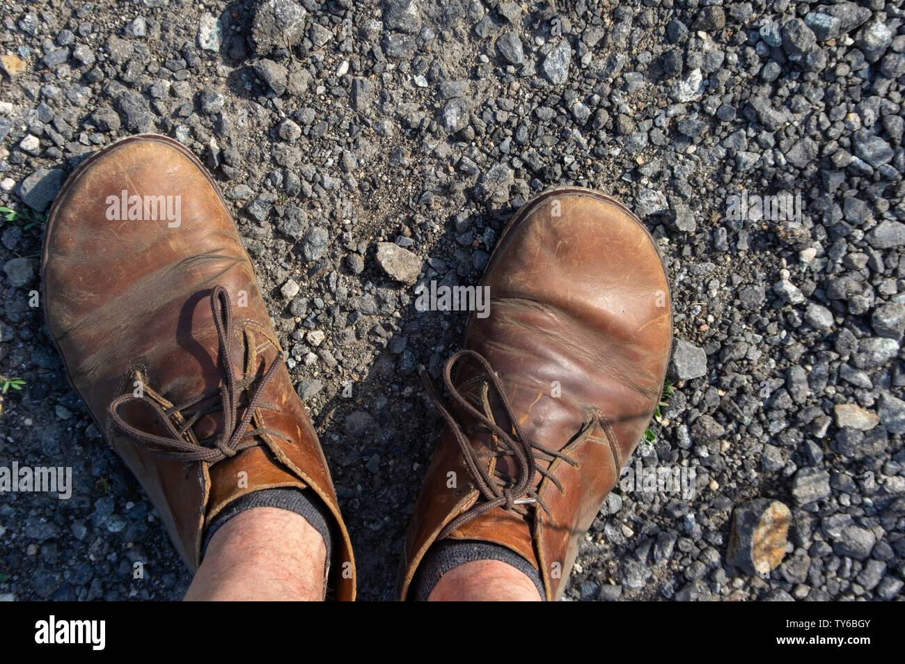 male feet in brown leather shoes top view Stock Photo