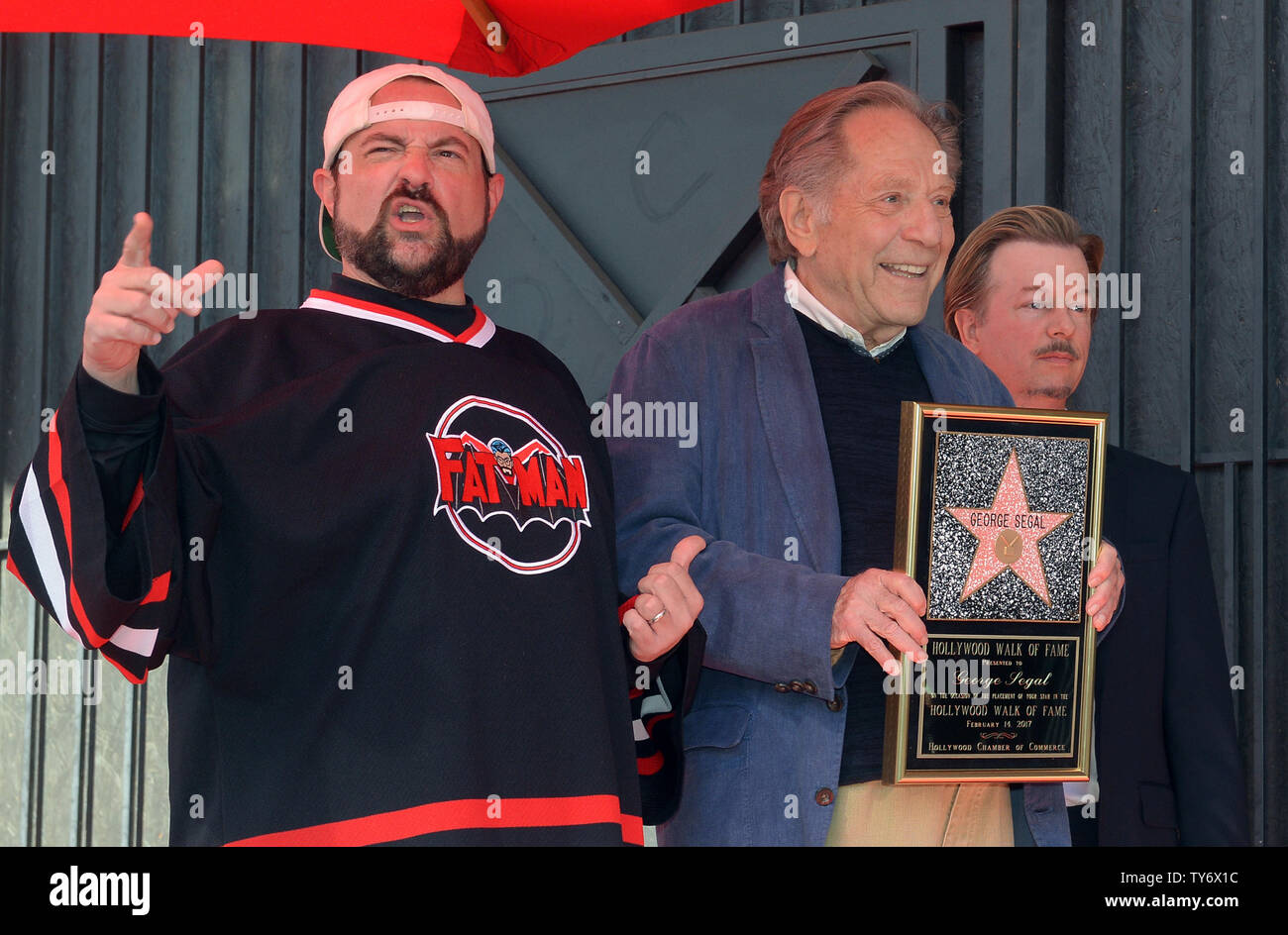 Actor George Segal holds a replica plaque as he is joined by director Kevin Smith (L) and actor David Spade during a ceremony honoring Segal with the 2,062nd star on the Hollywood Walk of Fame in Los Angeles on February 14, 2017. Photo by Jim Ruymen/UPI Stock Photo