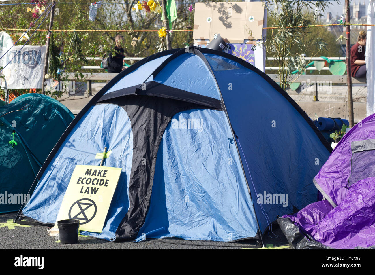 Make ecocide law sign against a tent for the Make ecocide law sign against a tent Stock Photo