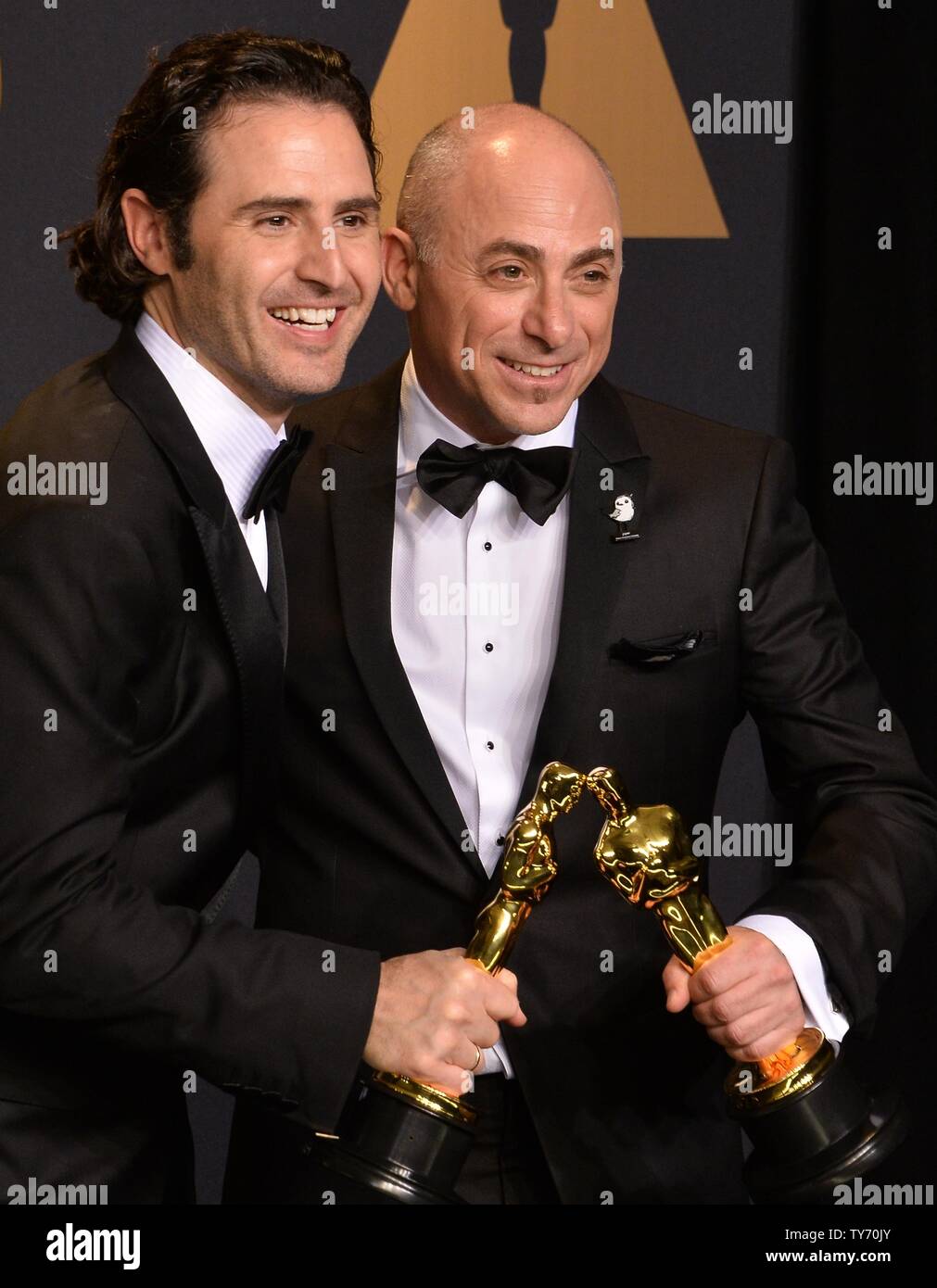 Director Alan Barillaro (L) and producer Marc Sondheimer, winners of the  award for Short Film (Animated) for 'Piper', appear backstage during the  89th annual Academy Awards at Loews Hollywood Hotel in the