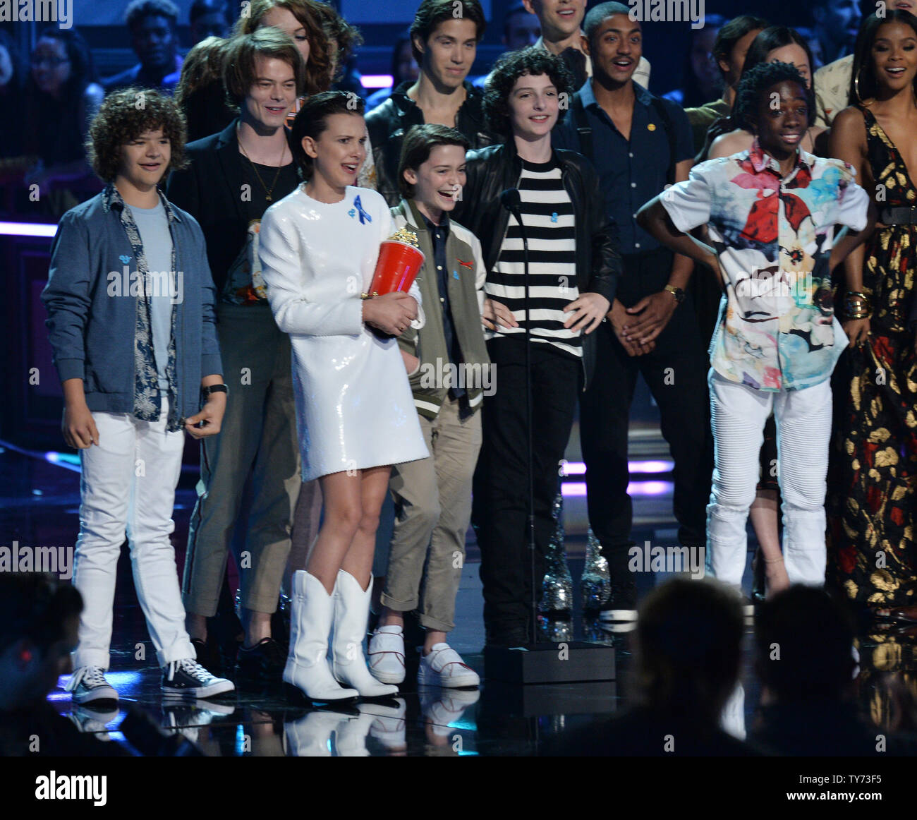 Actors Gaten Matarazzo, Charlie Heaton, Noah Schnapp, Natalia Dyer, Shannon Purser, Millie Bobby Brown, Finn Wolfhard, Joe Keery, and Caleb McLaughlin (L-R) accept the Show of the Year for 'Stranger Things' onstage during the MTV Movie & TV Awards at the Shrine Auditorium in Los Angeles on May 7, 2017. It will be the 26th edition of the awards, and will for the first time present honors for work in television as well as cinema.  Photo by Jim Ruymen/UPI Stock Photo
