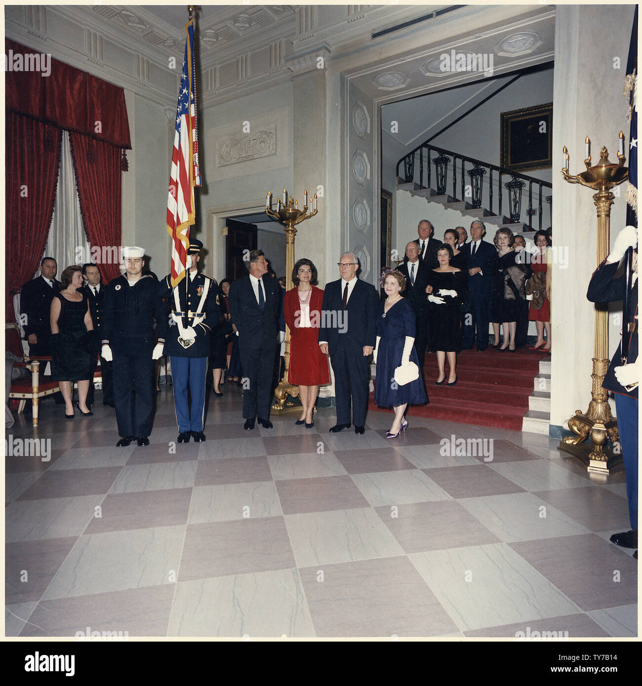 Judicial Reception. Color Guard, President Kennedy, Mrs. Kennedy, Chief Justice of the Supreme Court Earl Warren, Mrs. Warren, Associate Justice Hugo Black, Mrs. Black, Associate Justice William O. Douglas, Mrs. Douglas, Associate Justice Thomas Campbell Clark, Mrs. Clark, Associate Justice Potter Stewart, Mrs. Stewart, others. White House, Grand Staircase. Stock Photo