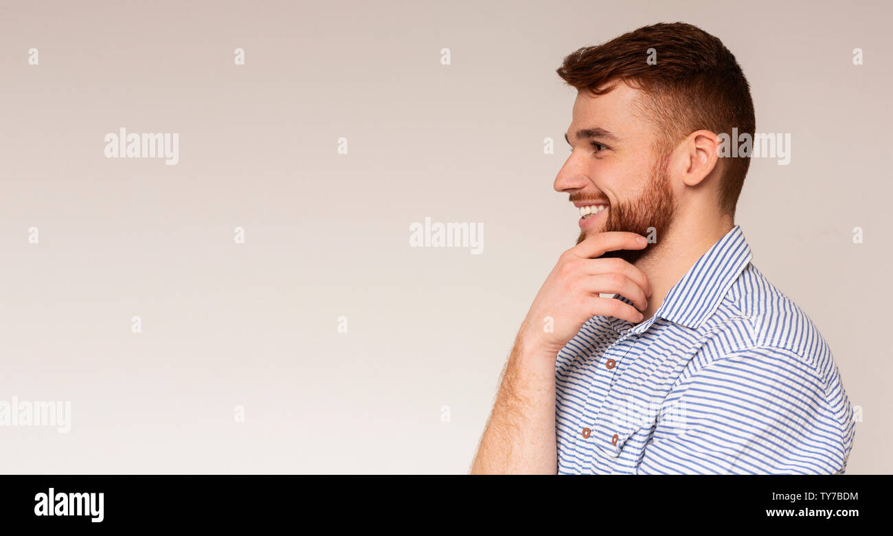 Young millennial man looking away at copy space and smiling Stock Photo