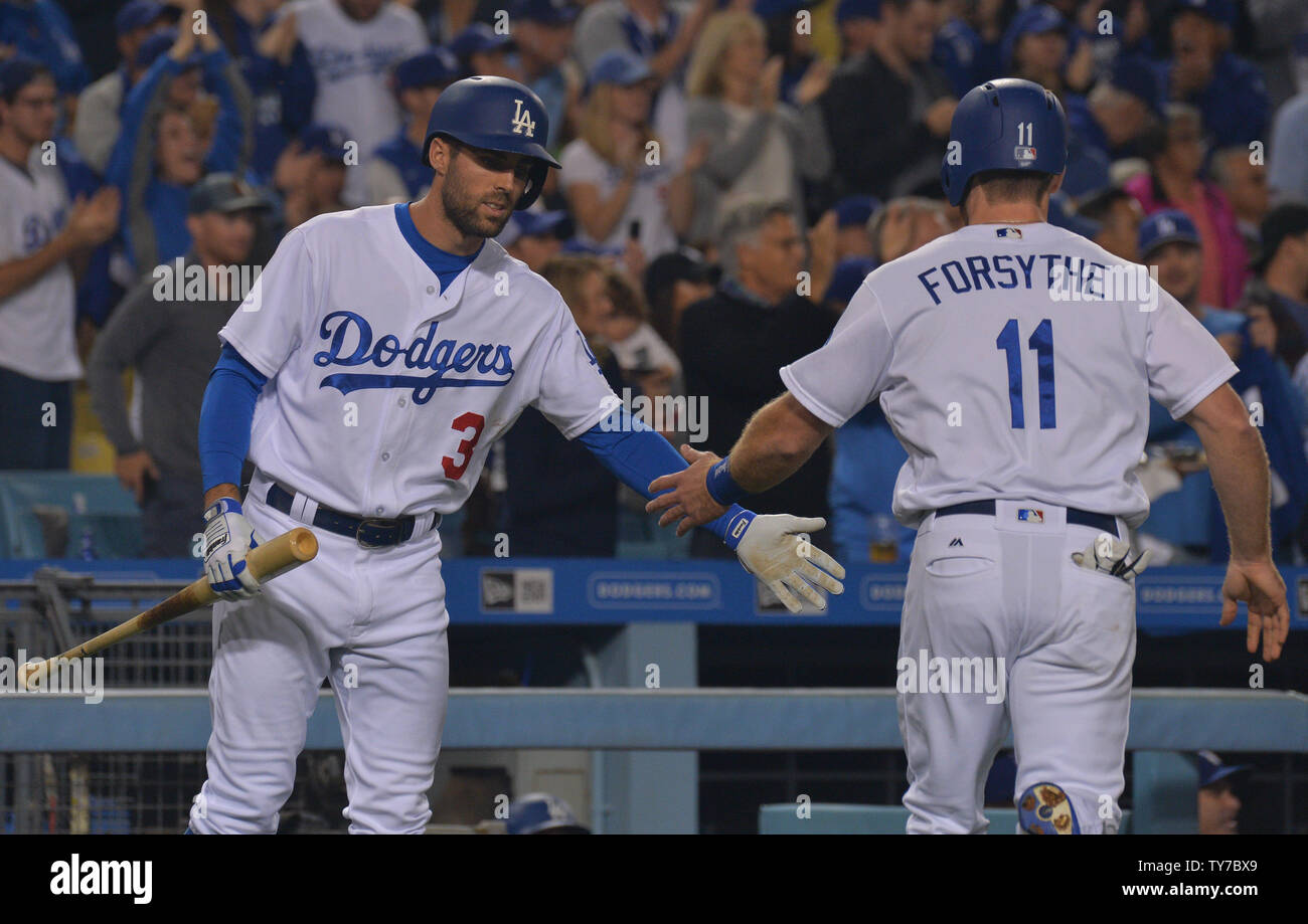 Los Angeles Dodgers' Logan Forsythe celebrates with teammate Chris Taylor after scoring on an extra base hit by pitcher rRch Hill in the third inning off San Francisco pitcher Jeff Samardzija.  Photo by Jim Ruymen/UPI Stock Photo