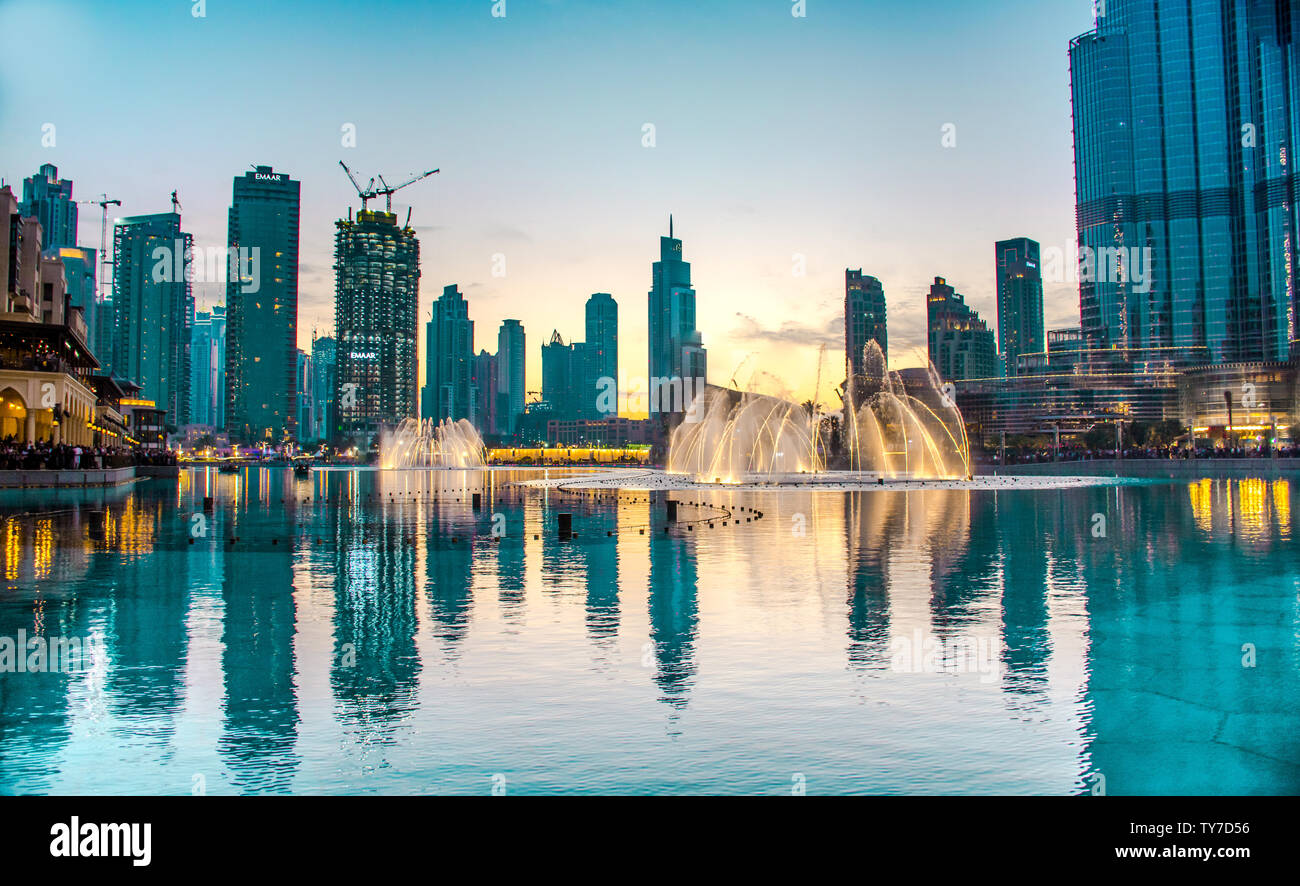 Dubai mall water fountain water dance colorful sunset at world tallest bullding Burjkhalifa Stock Photo