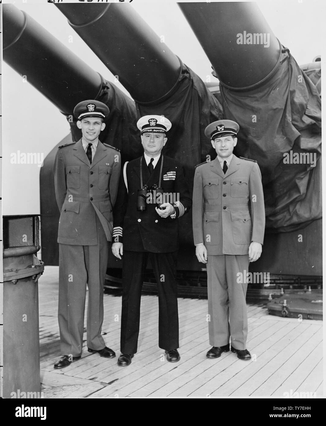 L to R Lt. Elsey, Captain James Vardaman, and ship's clerk Edwin L. Hoying stand on the