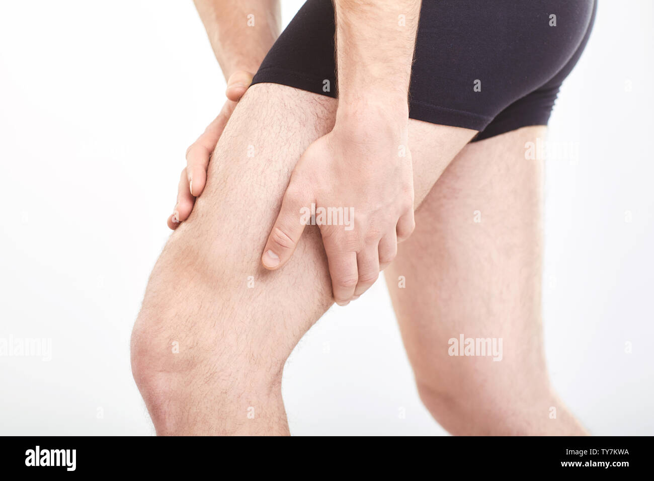 Man muscle strain injury in thigh. Sports injury. Man with pulled