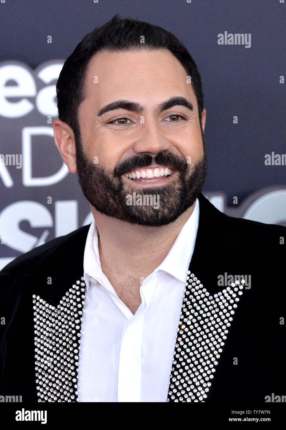 Radio host Enrique Santos arrives for the iHeartRadio Music Awards at The  Forum in Inglewood, California on March 11, 2018. Turner's TBS, TNT, and  truTV channels broadcasted the ceremony live from The