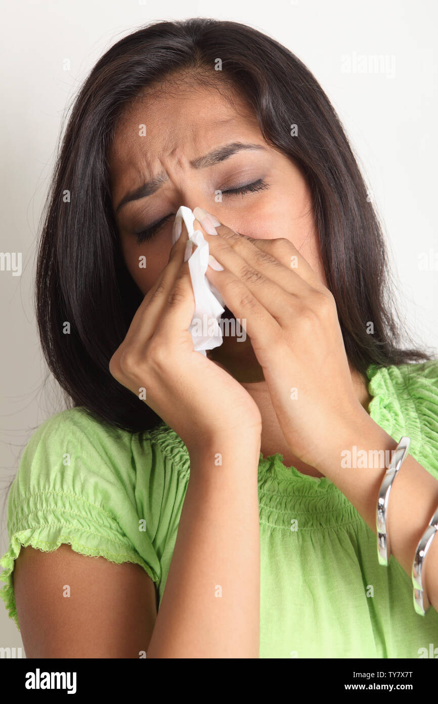 Woman blowing nose with handkerchief Stock Photo Alamy