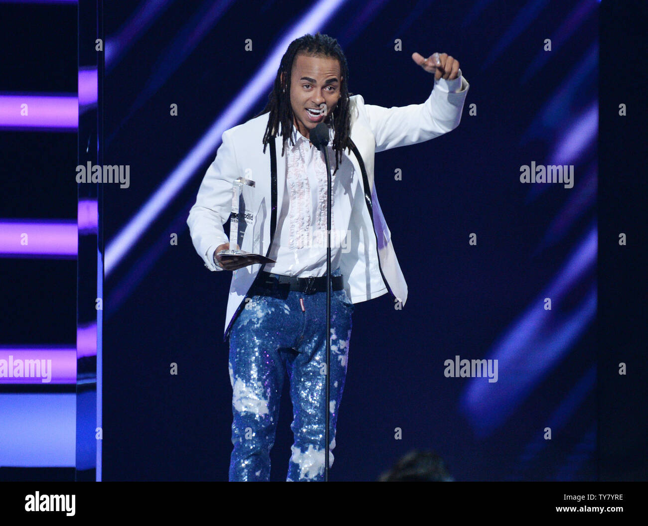 Ozuna accepts his Artist of the Year award onstage during the Billboard ...