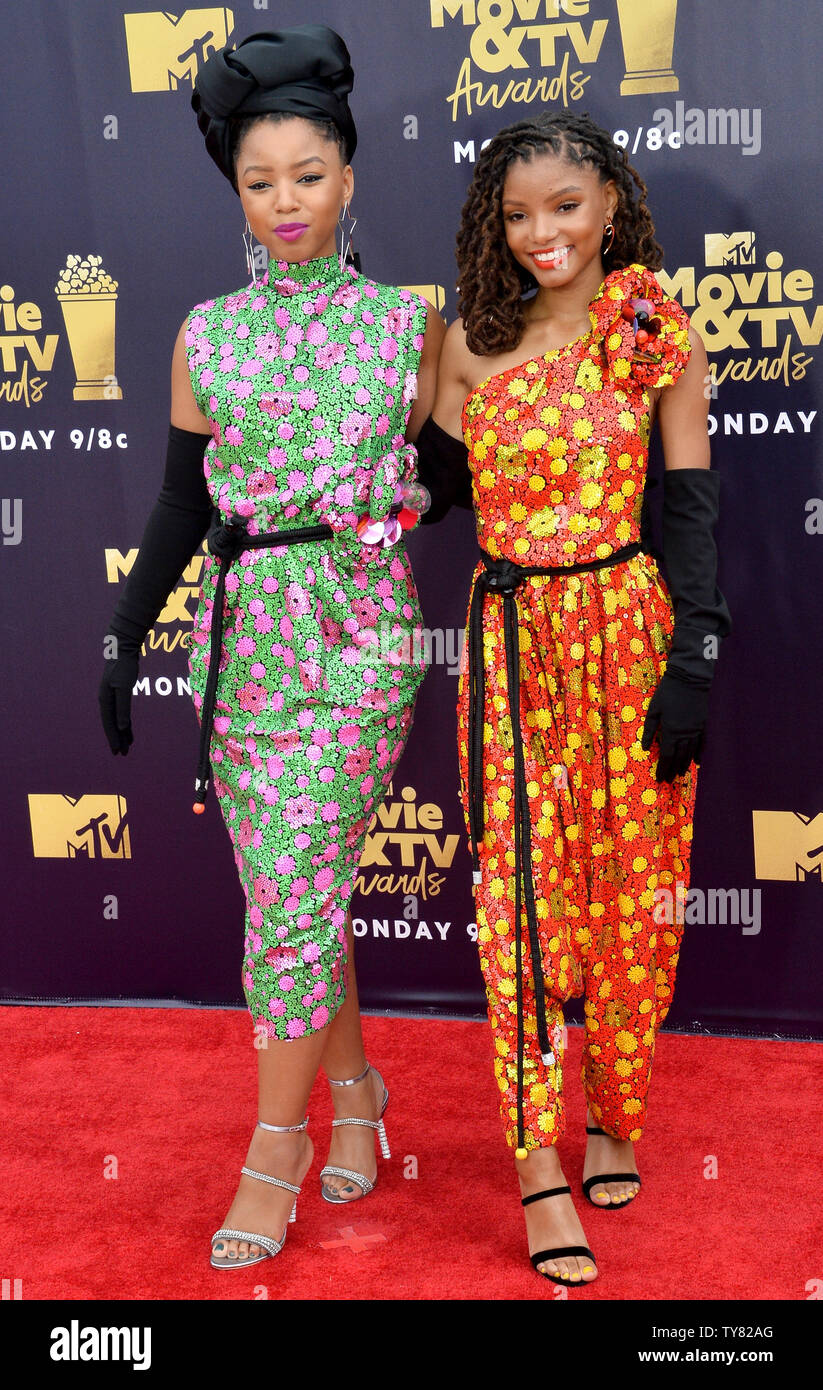 Halle Bailey (L) and Chloe Bailey of R&B duo Chloe X Halle attend the MTV  Movie & TV Awards at the Barker Hangar in Santa Monica, California on June  16, 2018. It