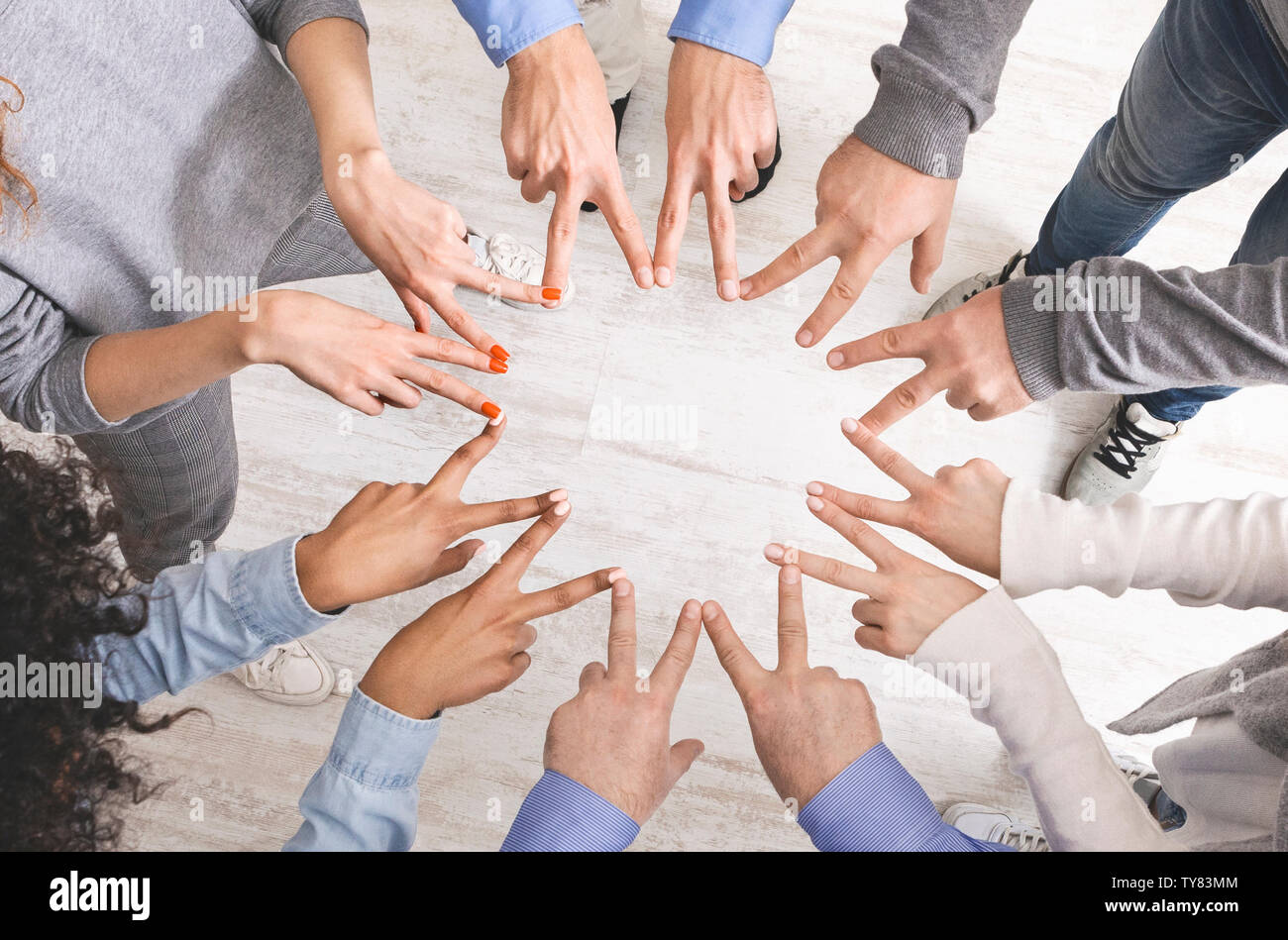 Group of hands showing peace hand sign, top view Stock Photo