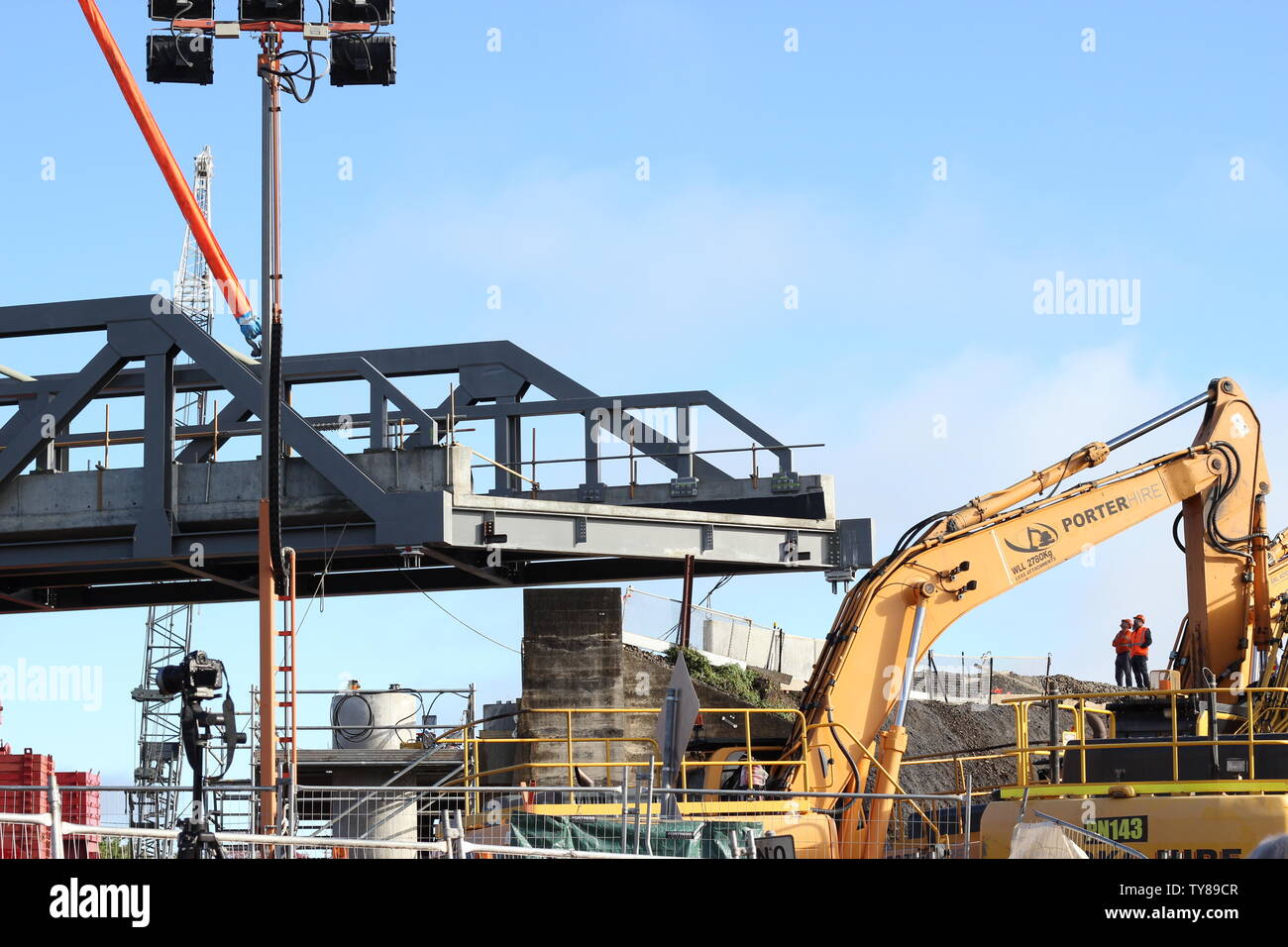 Steel section of rail lifted into place by large crane in Grafton NSW