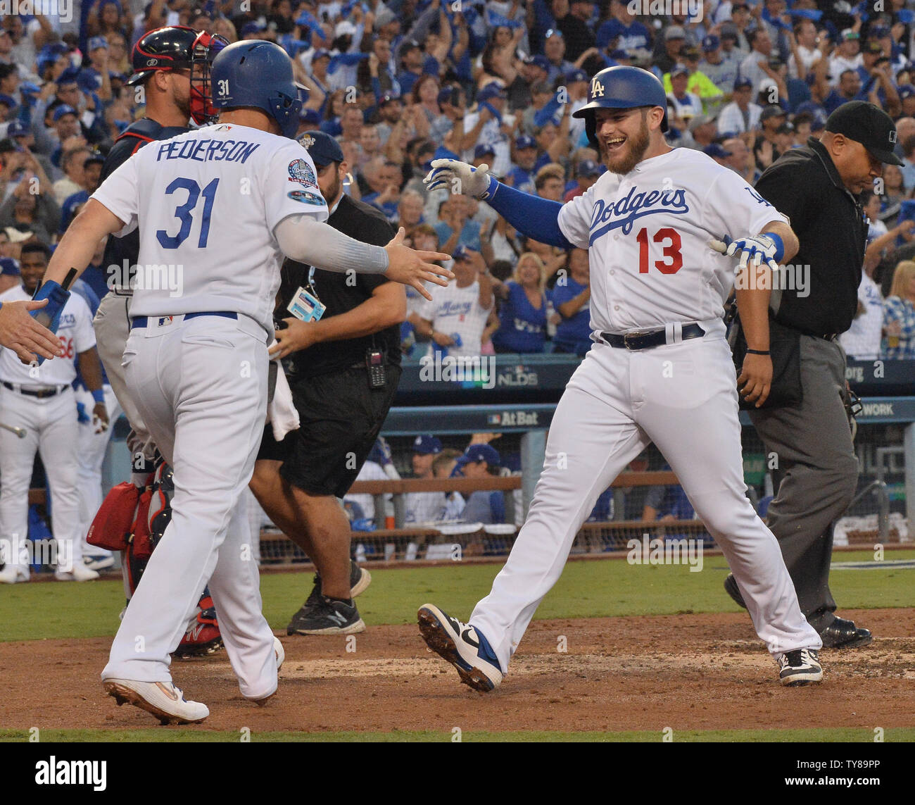 Los Angeles Dodgers Max Muncy (13) is greeted at home plate by Joc Pederson (31)after a three run home run off Atlanta Braves starting pitcher Mike Foltynewicz in the second inning of game one of the National League Division Series at Dodger Stadium in Los Angeles on October 4, 2018. Pederson scored on the blast.    Photo by Jim Ruymen/UPI Stock Photo