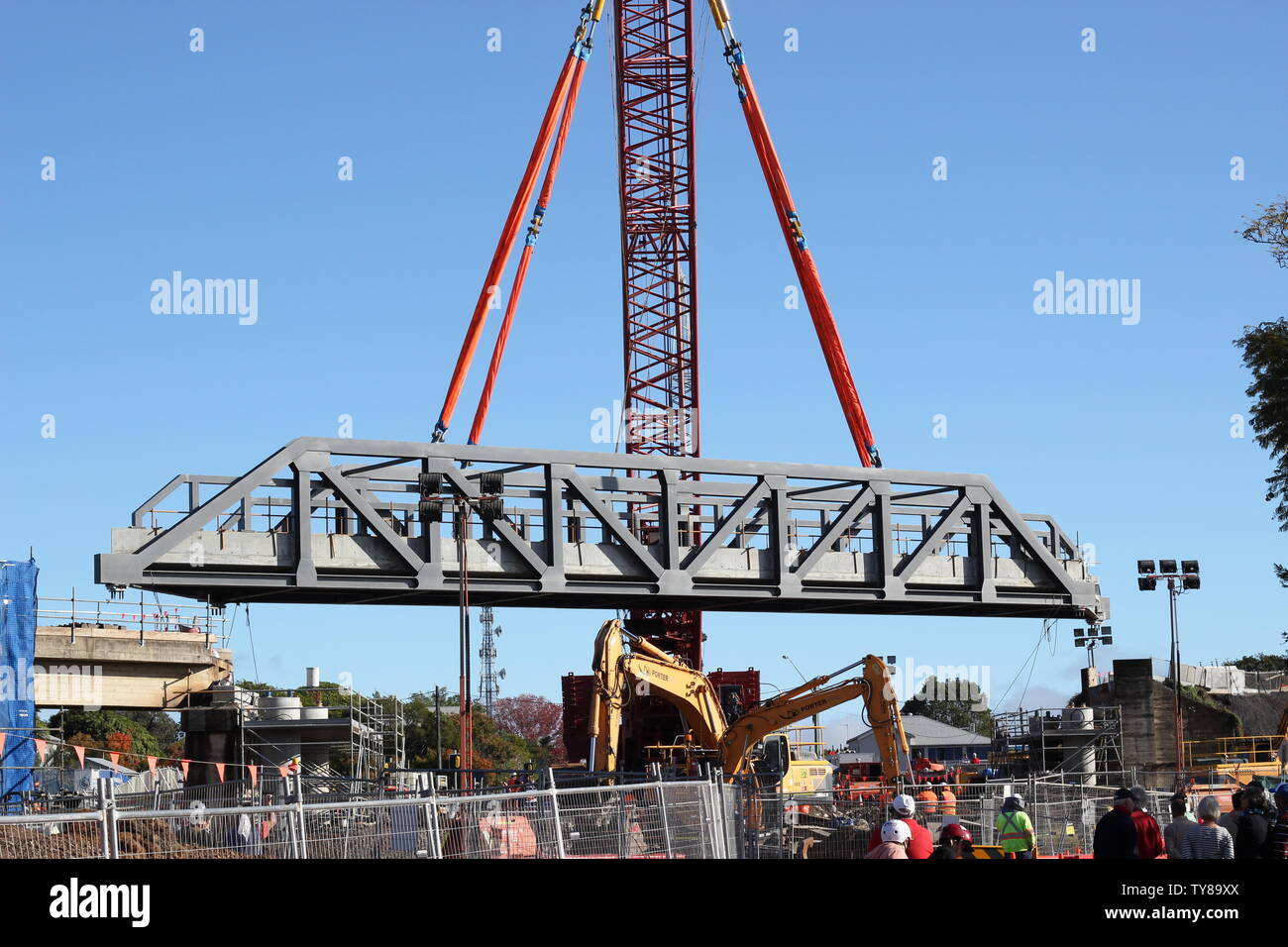 Steel section of rail lifted into place by large crane in Grafton NSW