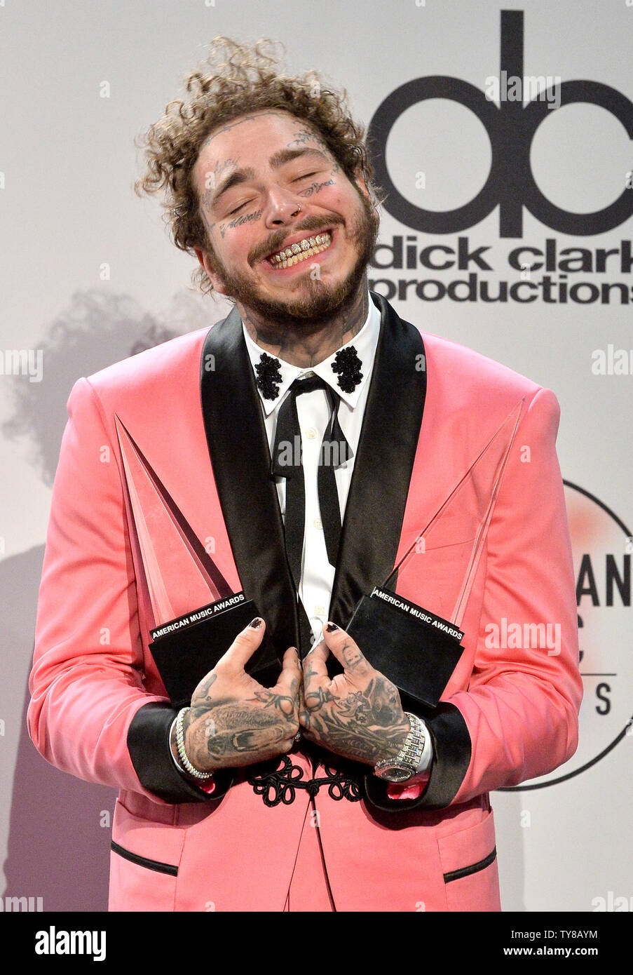 Rapper Post Malone appears backstage with his award for Favorite Male