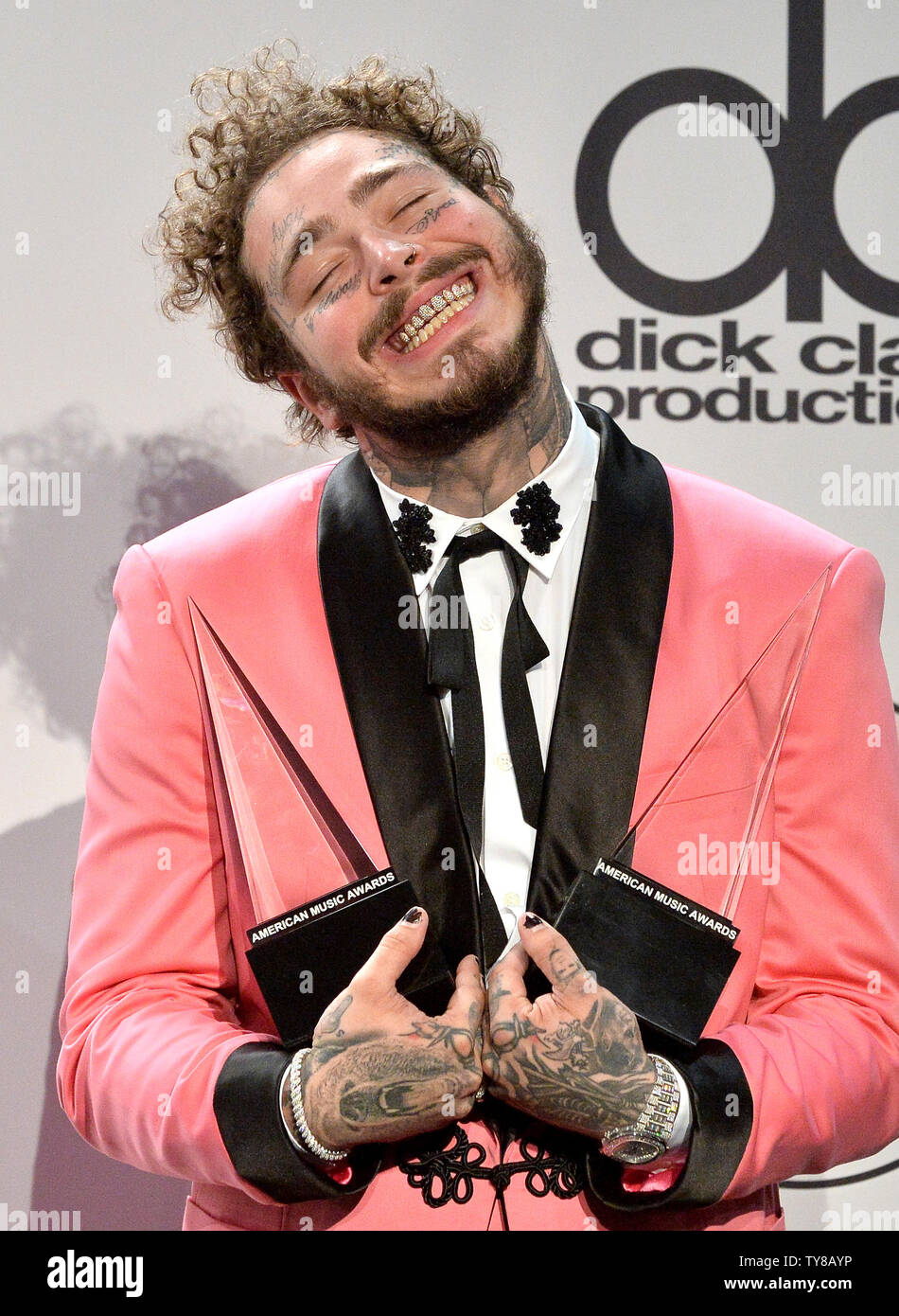 Rapper Post Malone appears backstage with his award for Favorite Male ...
