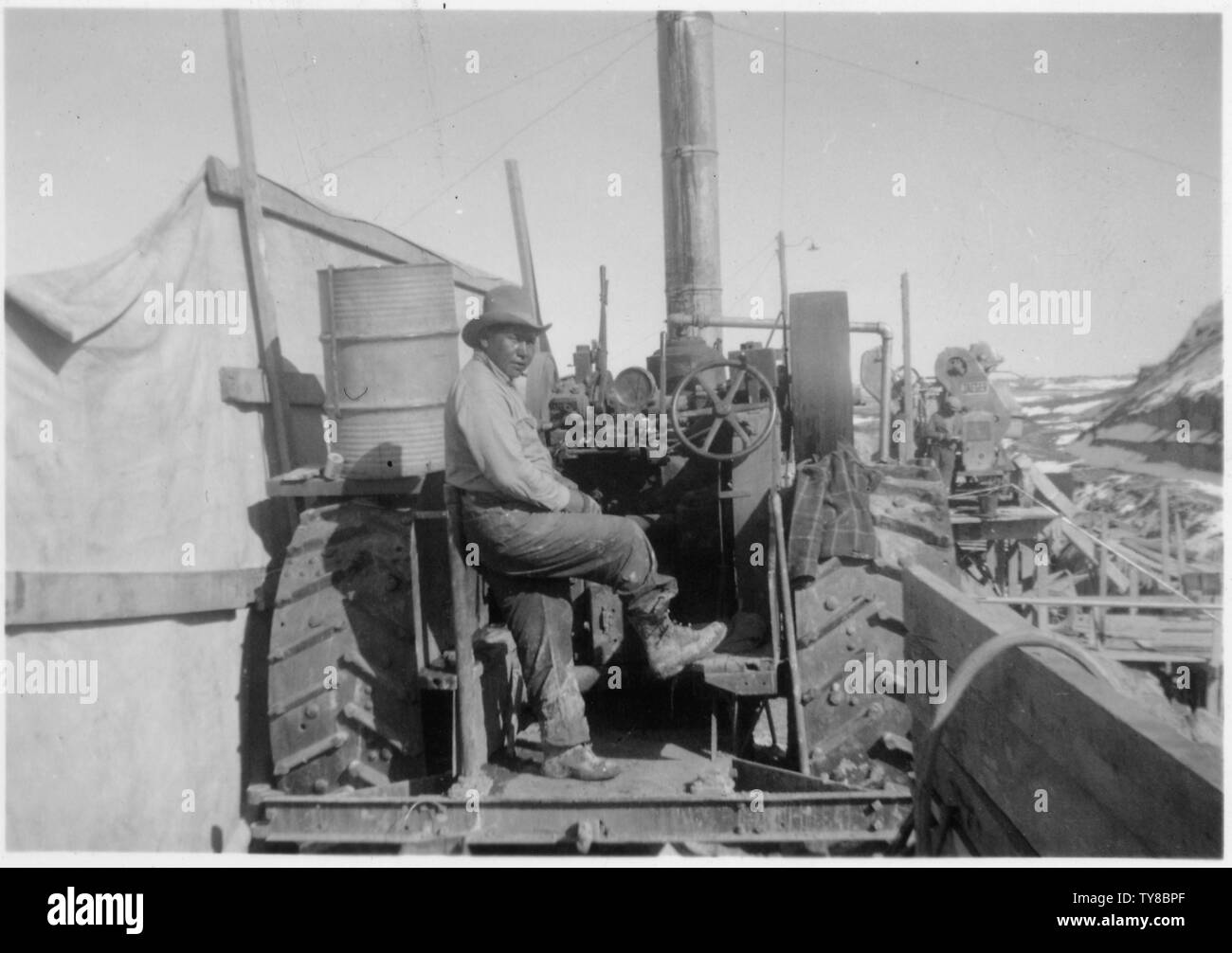 Man sits on steam engine Stock Photo - Alamy