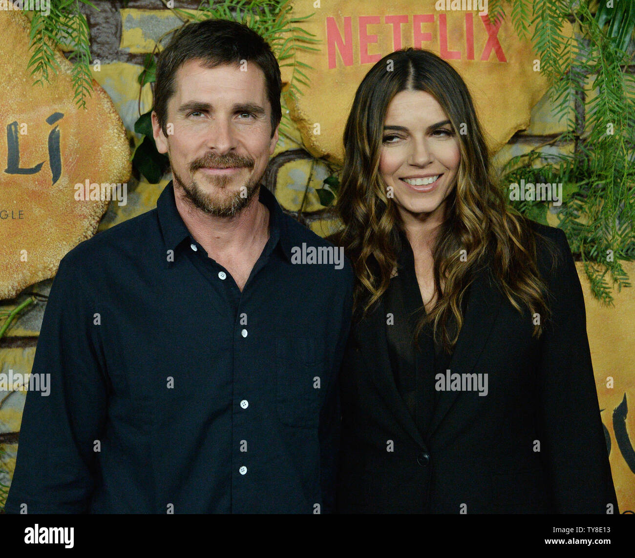 Cast member Christian Bale and his wife Sibi Blazic attend the premiere of the motion picture drama 'Mowgli: Legend of the Jungle' at the ArcLight Cinema Dome in the Hollywood section of Los Angeles on November 28, 2018. Based on the novel by Rudyard Kipling The story follows the upbringing of the human child Mowgli raised by a pack of wolves in the jungles of India. As he learns the often harsh rules of the jungle, under the tutelage of a bear named Baloo and a black panther named Bagheera, Mowgli becomes accepted by the animals of the jungle as one of their own, except for one; the fearsome Stock Photo