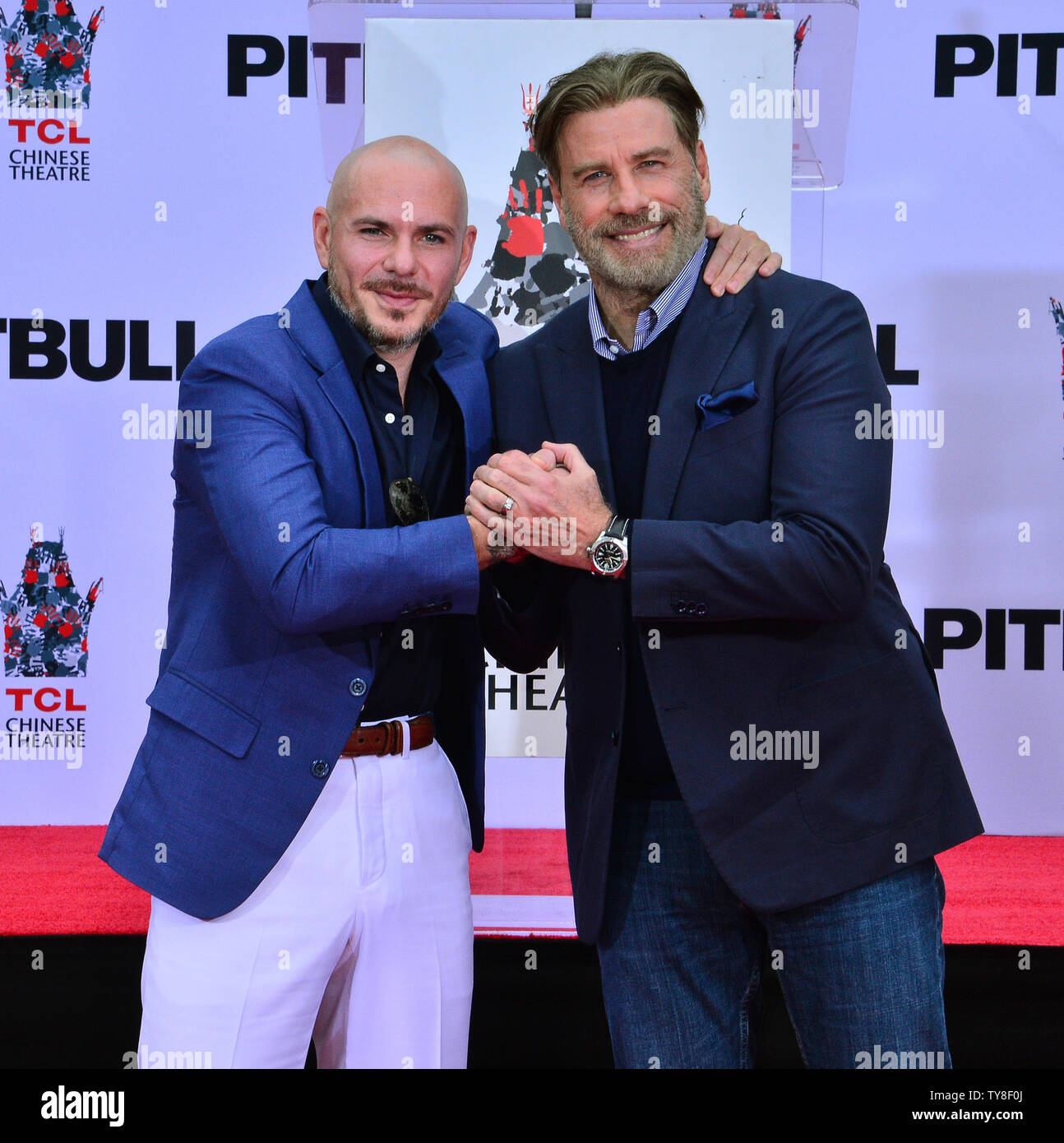 https www alamy com american rapper armando christian perez known by the stage name pitbull is joined by actor john travolta during a hand and footprint ceremony immortalizing him in the forecourt of the tcl chinese theatre formerly graumans in the hollywood section of los angeles on december 14 2018 photo by jim ruymenupi image257728258 html