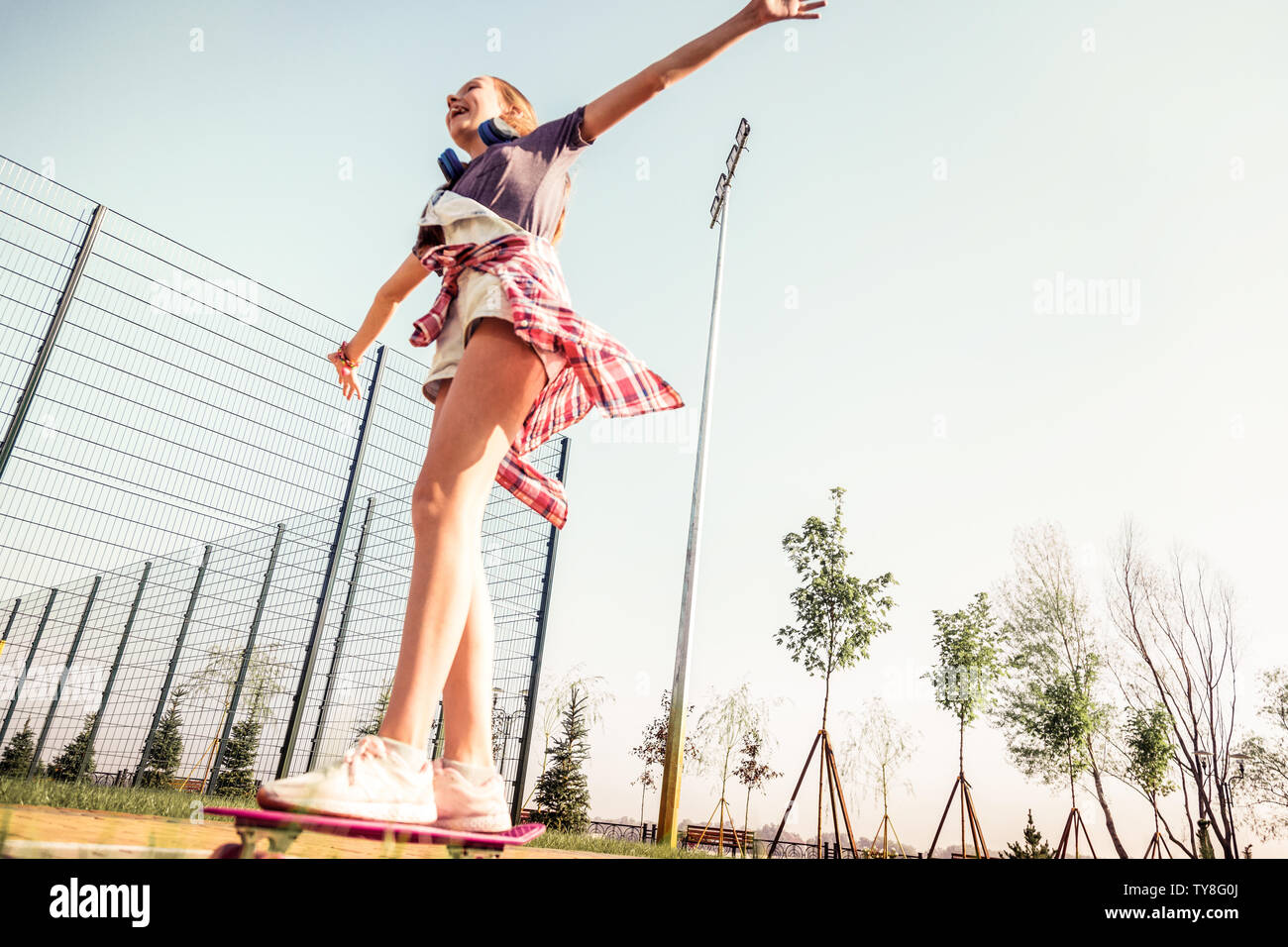 Active adult woman longboarder riding longboard on empty road. Female relax  on skateboard after work Stock Photo - Alamy