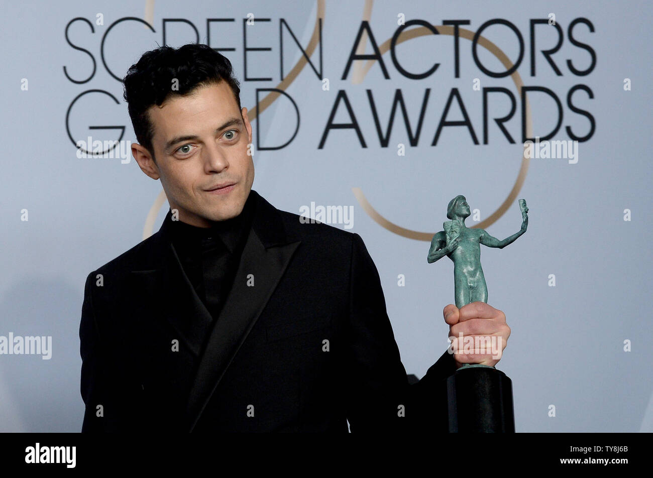 Rami Malek appears backstage with the award for Outstanding Performance