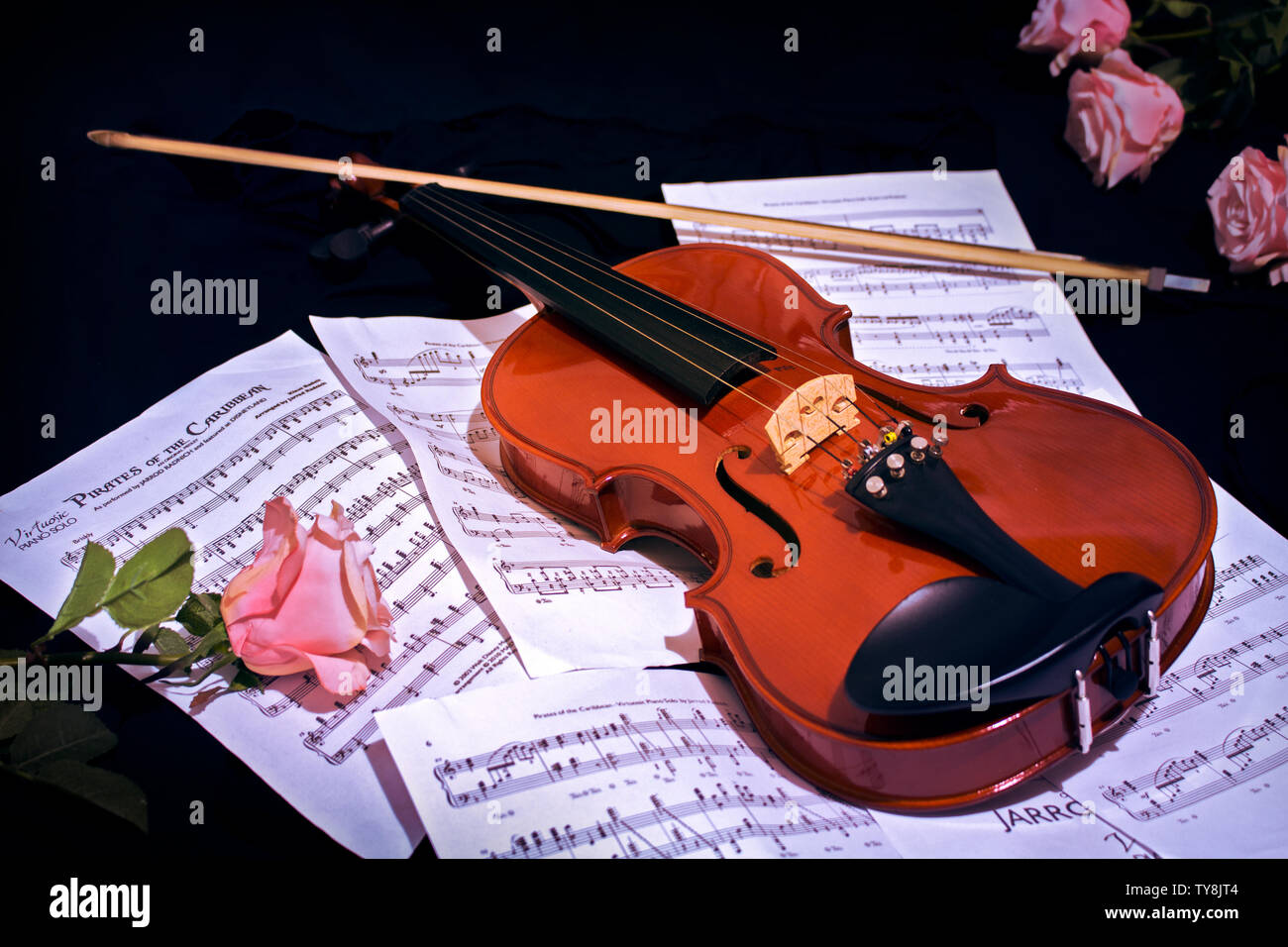 Violin lied above music sheet Stock Photo