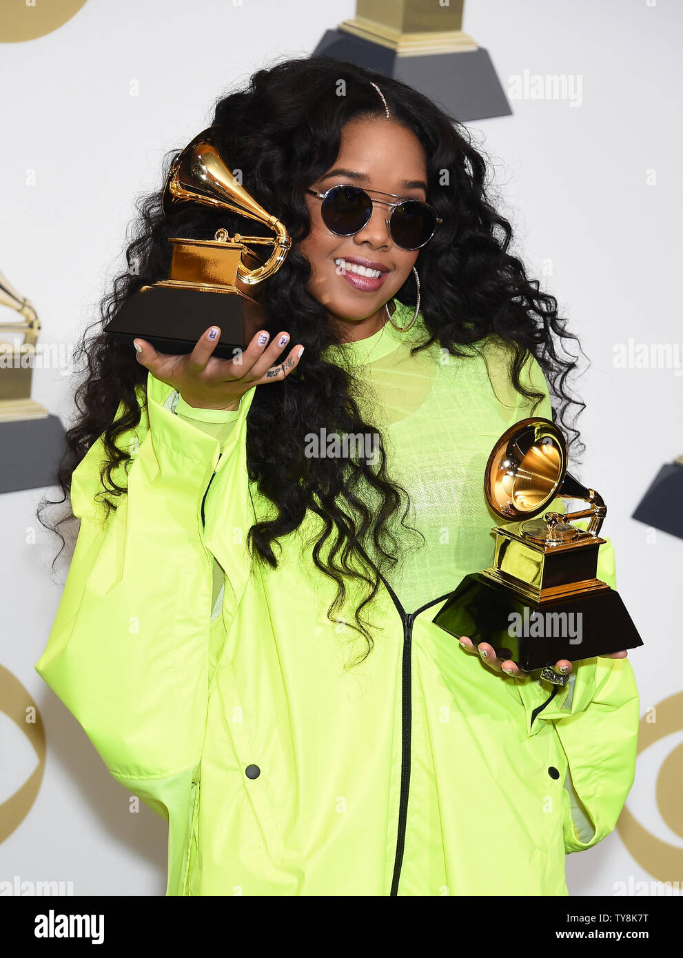 H.E.R. appears backstage with her awards for Best R&B Performance for ...