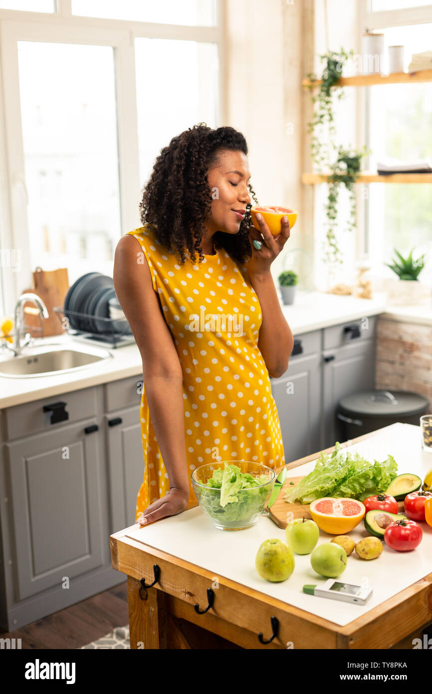 Pregnant lady smelling a half of grapefruit Stock Photo Alamy