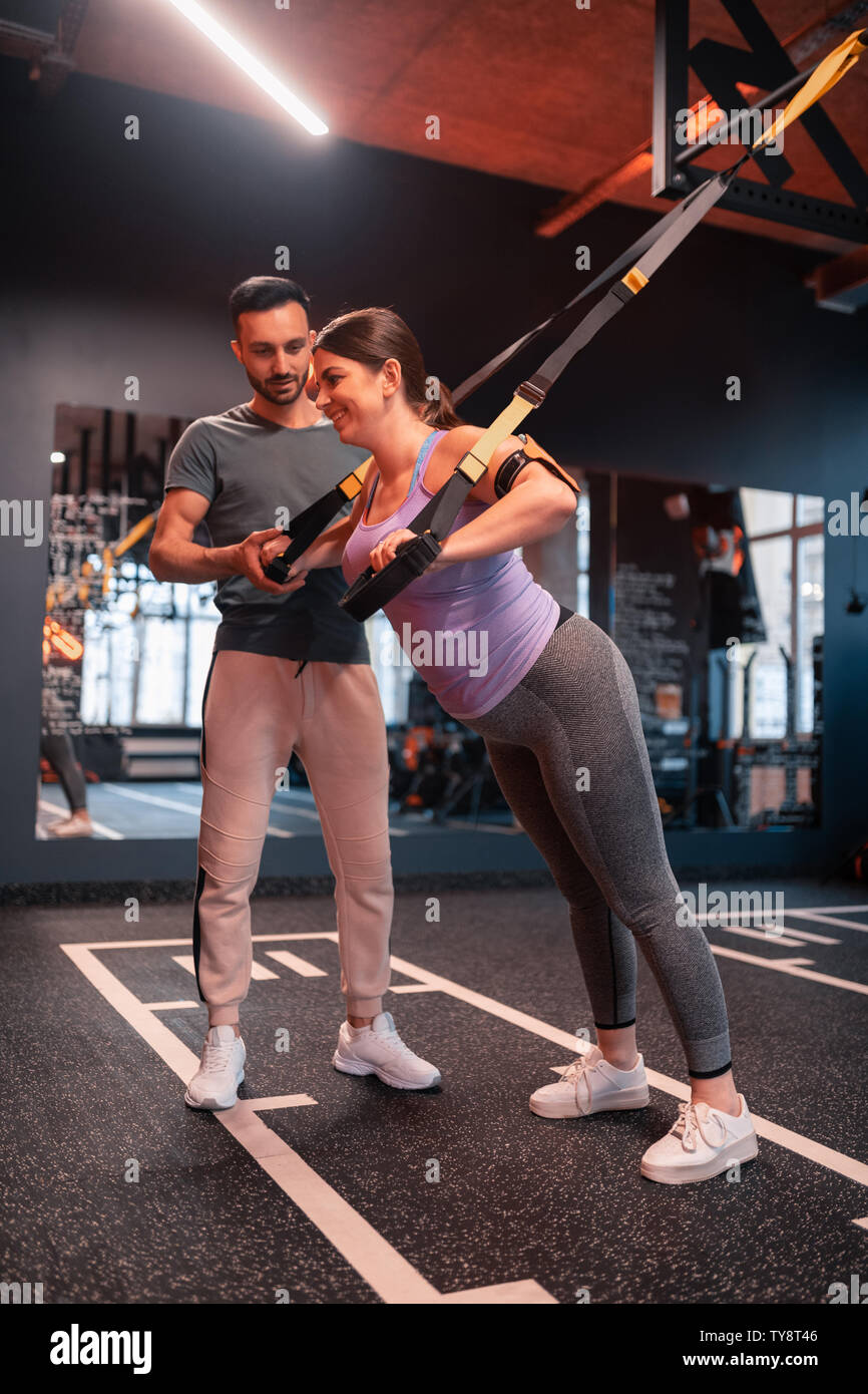 Overweight woman feeling positive trying TRX exercises for arms Stock Photo  - Alamy