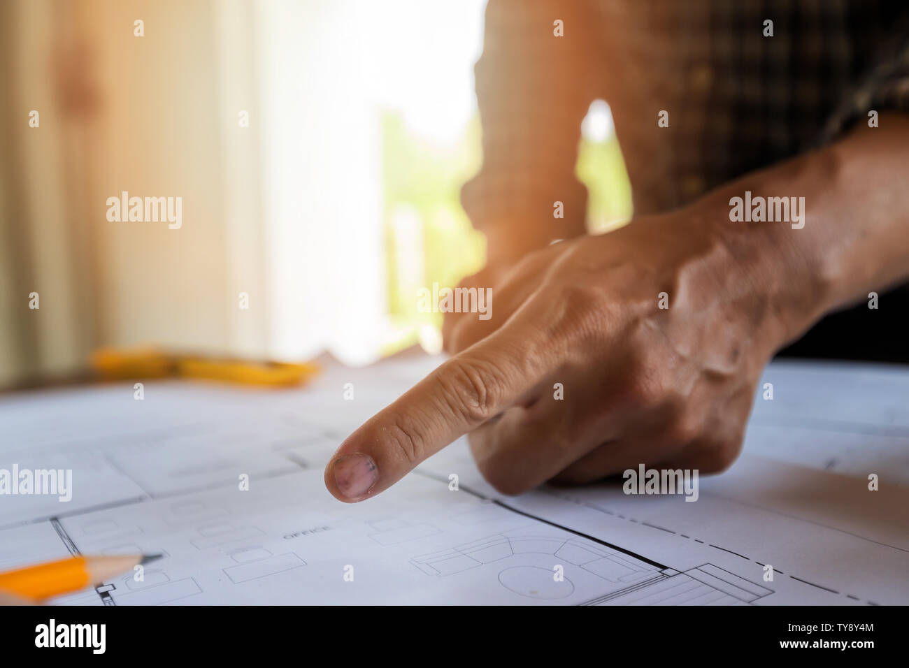 An architect or engineer pointing on blueprint, architectural concept Stock Photo
