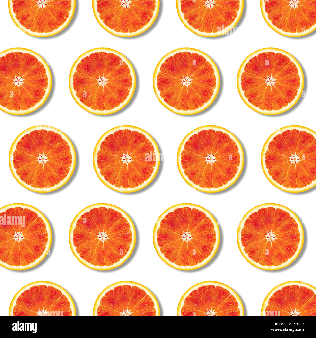 Red orange fruit slices pattern on white background. Minimal flat lay top view food texture Stock Photo