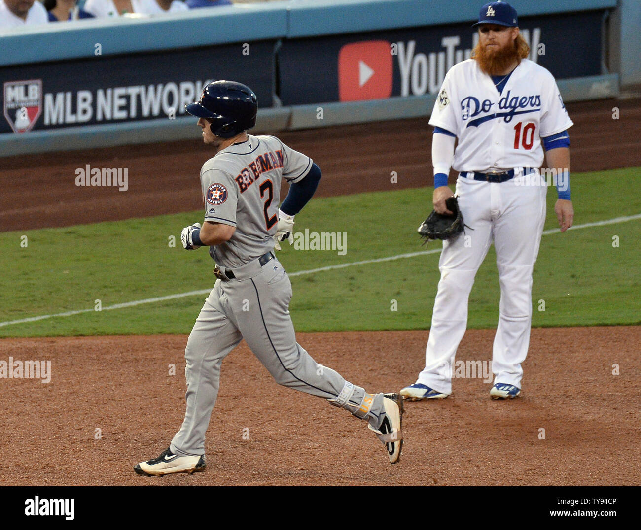 Houston Astros third baseman Alex Bregman (2) runs the bases past Los Angeles Dodgers third baseman Justin Turner after hitting a solo home run in the fourth inning of the 2017 MLB World Series game one at Dodger Stadium in Los Angeles, California on October 24, 2017.  Photo by Jim Ruymen/UPI Stock Photo