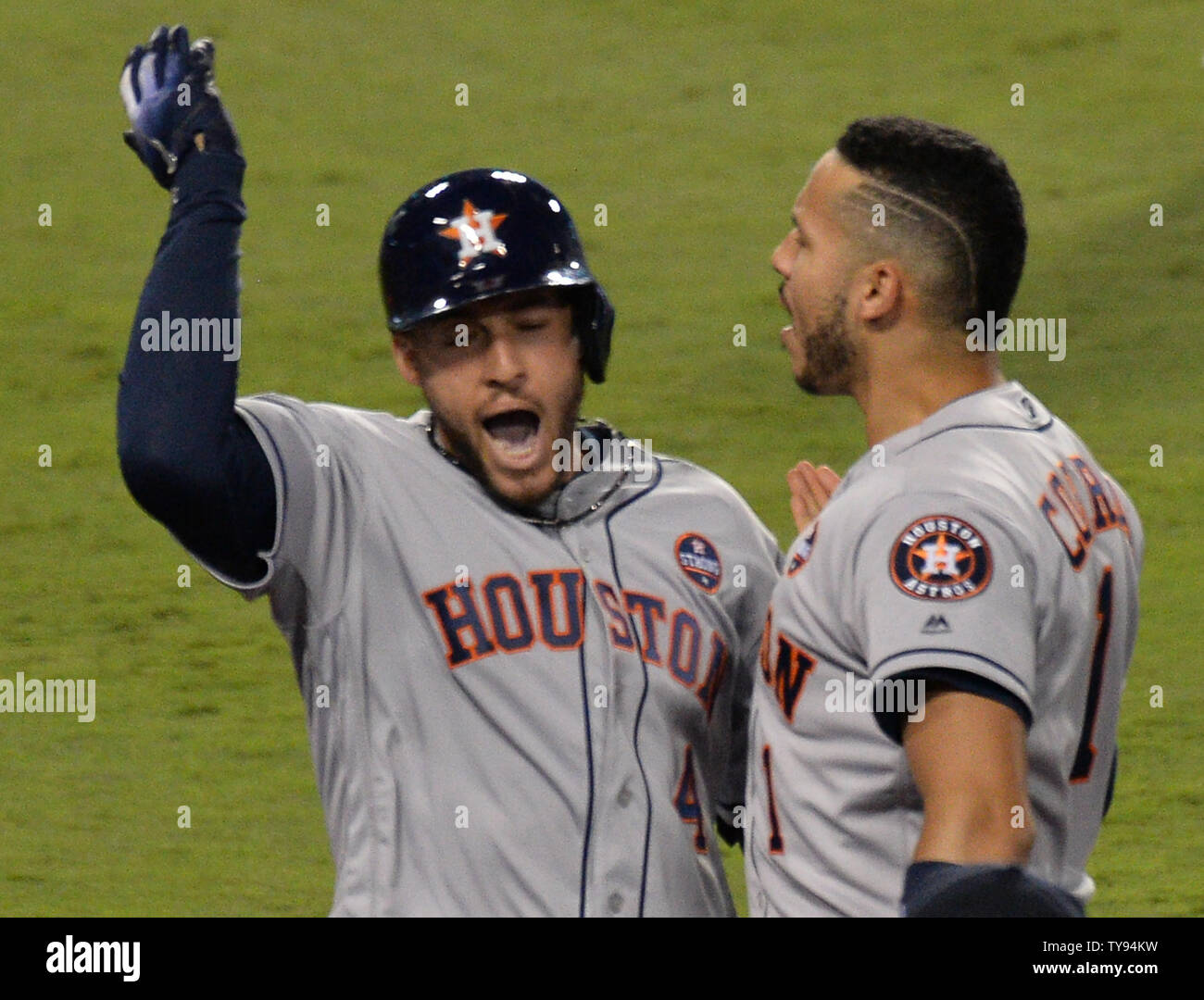 Houston Astros center fielder George Springer (L) celebrates with teammate  Carlos Correa after hitting a solo home run against the Los Angeles Dodgers  in the third inning of the 2017 MLB World