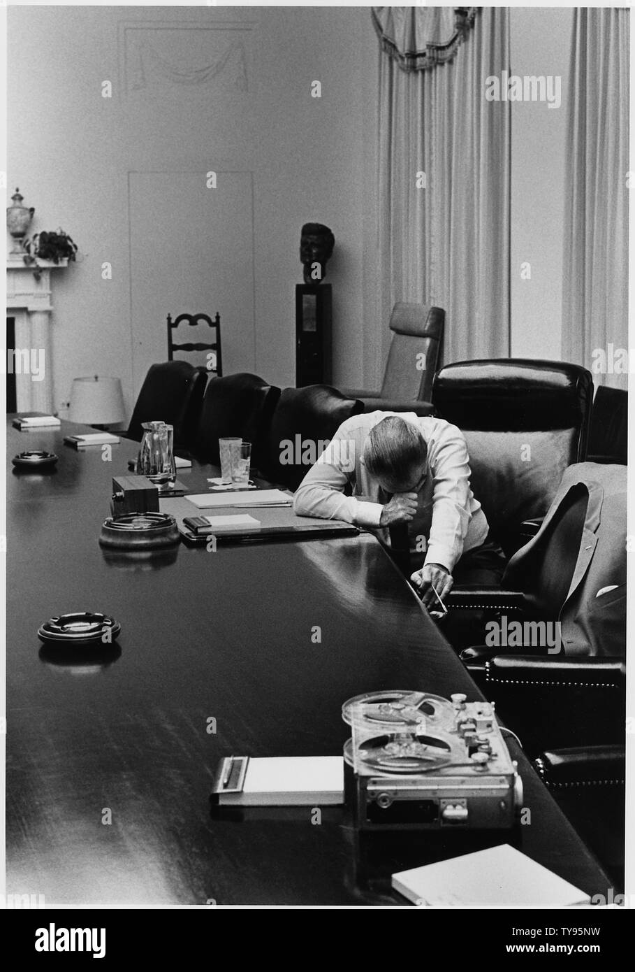 Moods: President Lyndon B. Johnson listens to tape sent by Captain Charles Robb from Vietnam; Scope and content:  Location: White House Cabinet Room. Depicted: President Lyndon B. Johnson. Stock Photo