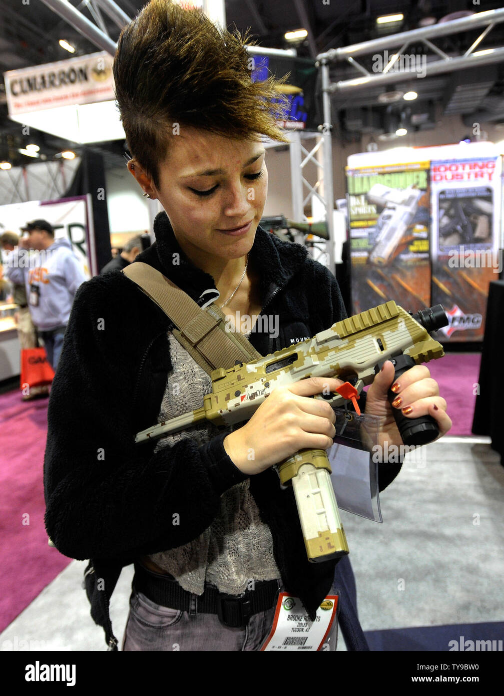 Attendee Brooke Roberts of Tucson, Ariz. examines a machine gun at the