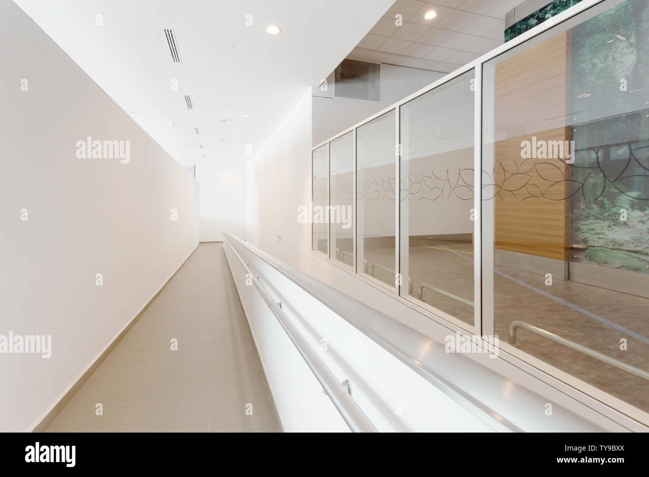 Modern office corridor with wheelchair pathway Stock Photo