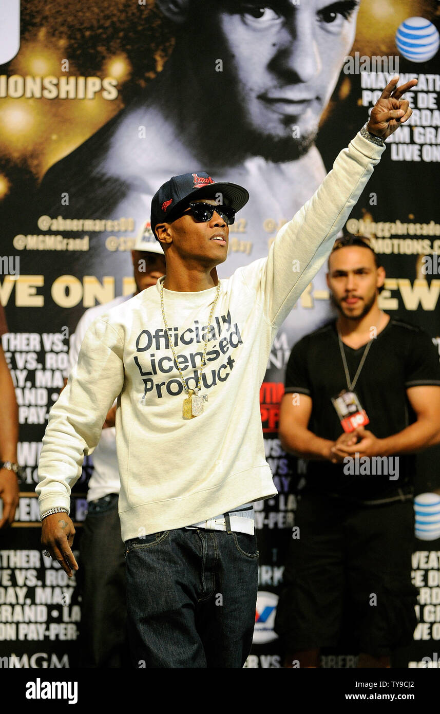 Boxer Zab Judah waves to the crowd during the weighin ceremony at the