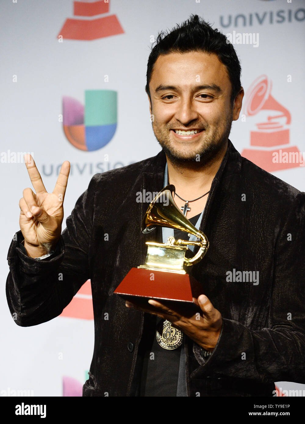 Singer Alex Campos hold the award he won for Best Spanish Christian Album for 'Regreso A Ti,' backstage at the Latin Grammy Awards at the Mandalay Bay Events Center in Las Vegas, Nevada on November 21, 2013.    UPI/Jim Ruymen Stock Photo