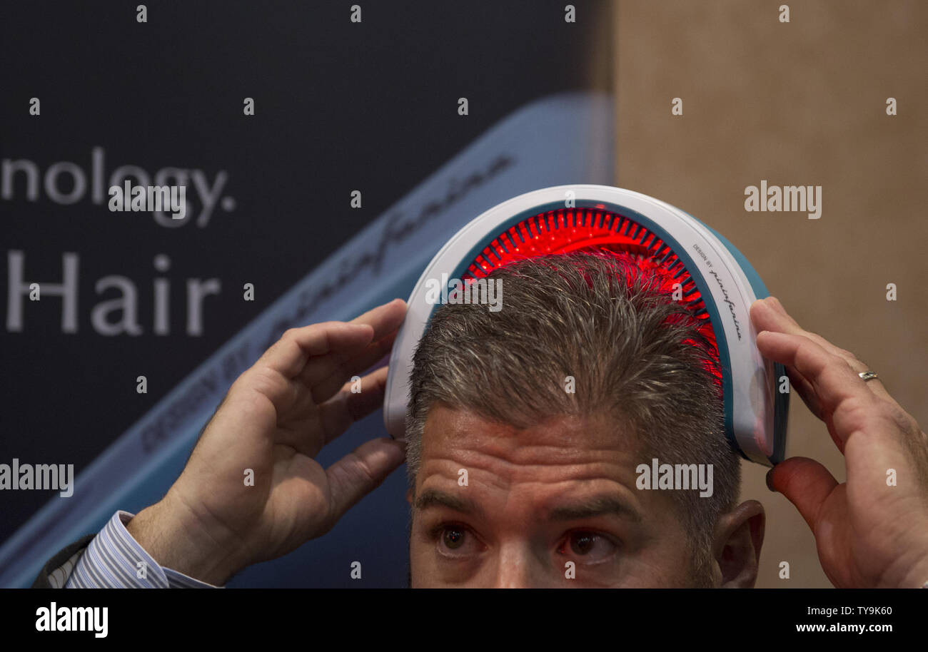 Exhibitor Jim Smeriglio demonstrates a HairMax Laserband laser hair growth device at Unveiled, ahead of the 2016 International CES, a trade show of consumer electronics, in Las Vegas, Nevada, January 4, 2016.     Photo by Molly Riley/UPI Stock Photo