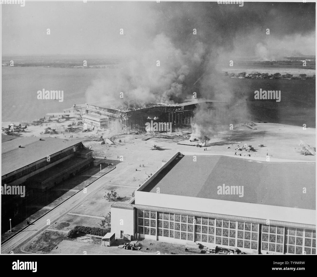Naval photograph documenting the Japanese attack on Pearl Harbor, Hawaii which initiated US participation in World War II. Navy's caption: Burning barracks at Ford Island, Pearl Harbor, Hawaii, after being attacked by Japanese aircraft on Dec.7, 1941.; Scope and content:  This photograph was originally taken by a Naval photographer immediately after the Japanese attack on Pearl Harbor, but came to be filed in a writ of application for habeas corpus case (number 298) tried in the US District Court, District of Hawaii in 1944. The case, In Re Lloyd C. Duncan related to imposition of martial law Stock Photo