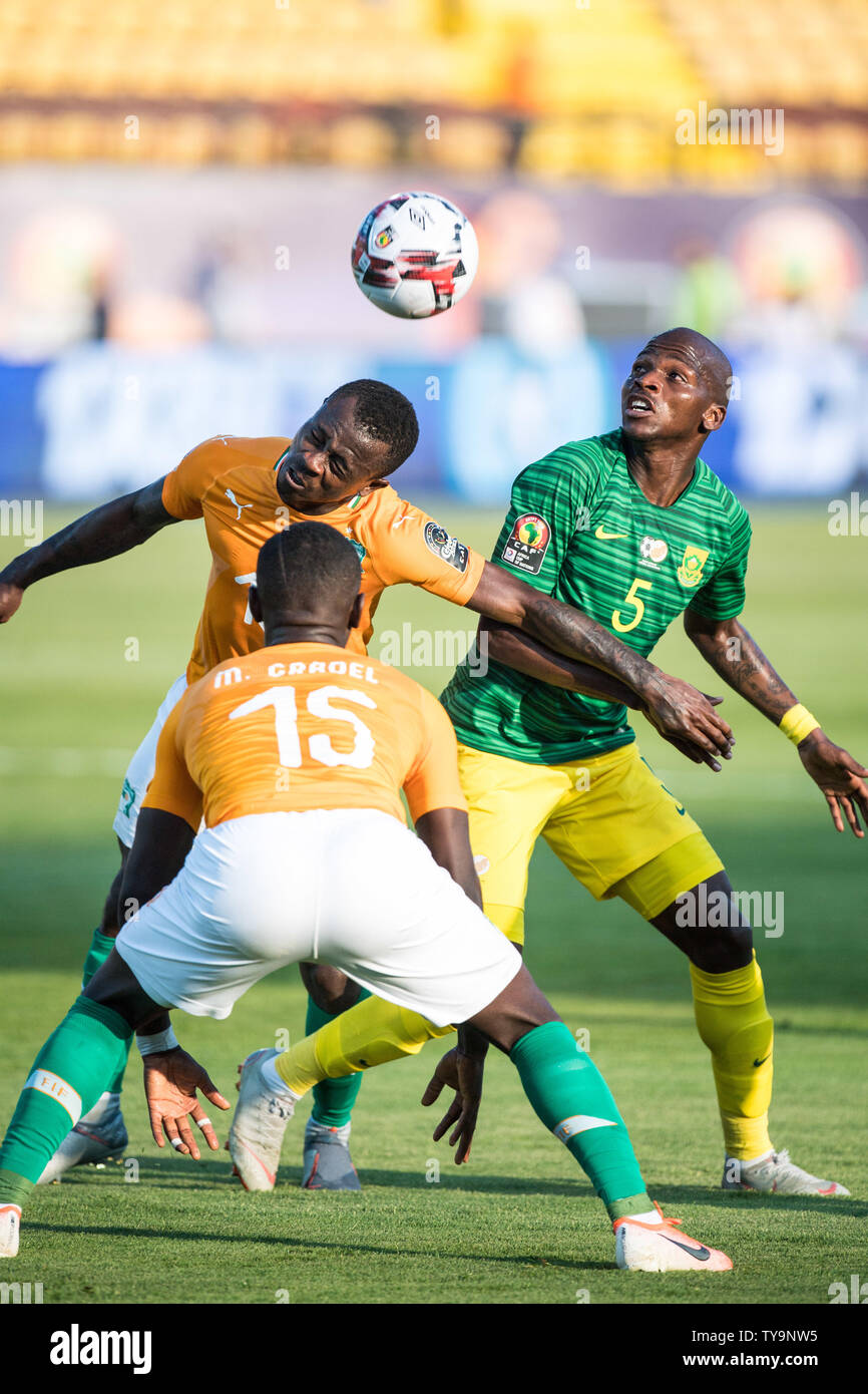 CAIRO, EGYPT - JUNE 24: Max Alain Gradel and Jean Michael Seri of Cote d'Ivoire and Serge Wilfried Kanon of South Africa challenge for ball during the 2019 Africa Cup of Nations Group D match between Cote d'Ivoire and South Africa at Al-Salam Stadium on June 24, 2019 in Cairo, Egypt. (Photo by Sebastian Frej/MB Media) Stock Photo