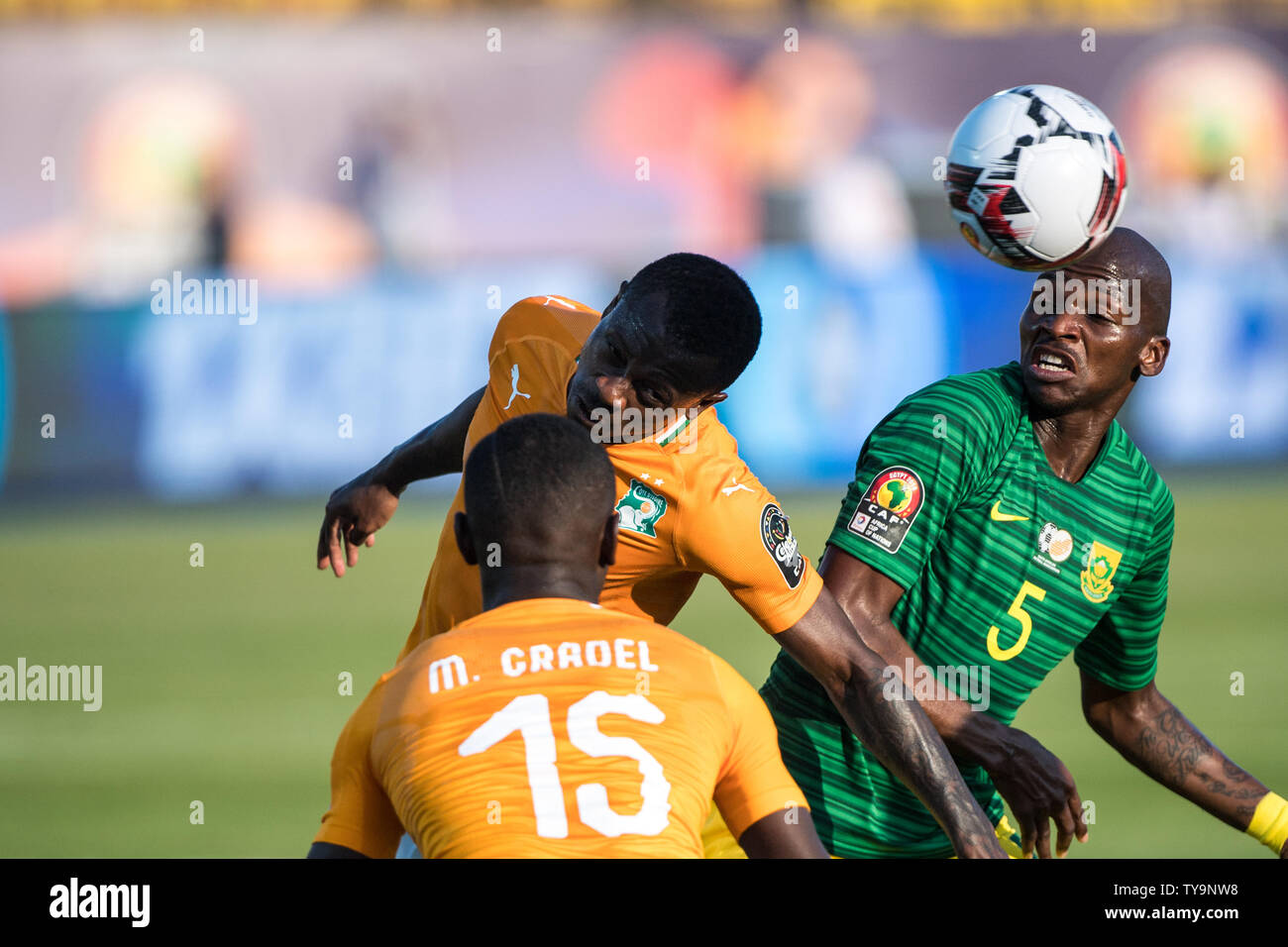 CAIRO, EGYPT - JUNE 24: Max Alain Gradel and Jean Michael Seri of Cote d'Ivoire and Serge Wilfried Kanon of South Africa challenge for ball during the 2019 Africa Cup of Nations Group D match between Cote d'Ivoire and South Africa at Al-Salam Stadium on June 24, 2019 in Cairo, Egypt. (Photo by Sebastian Frej/MB Media) Stock Photo