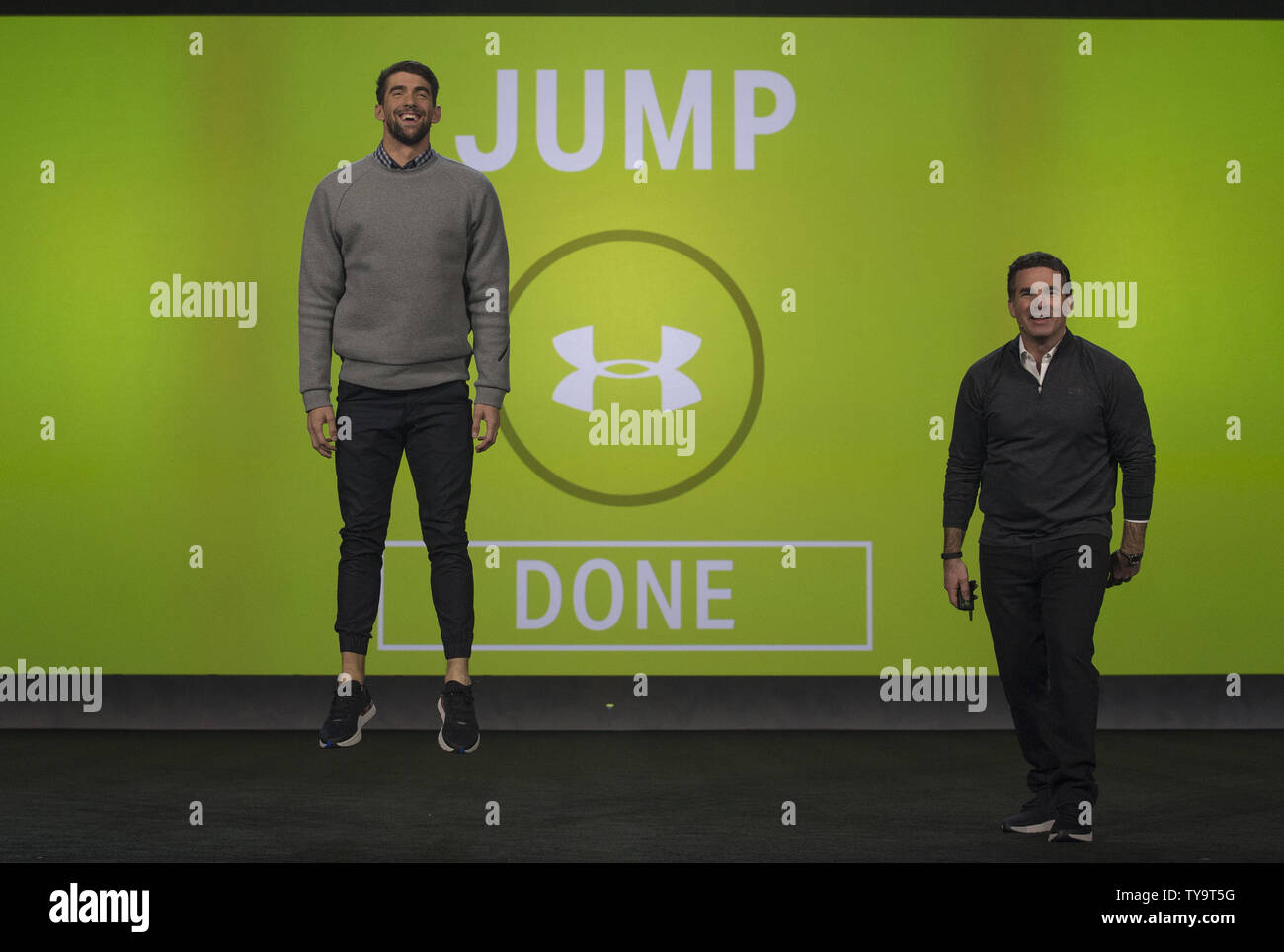 Michael Phelps performs a jump test on stage with Kevin Plank, Under Armour  Founder and CEO,